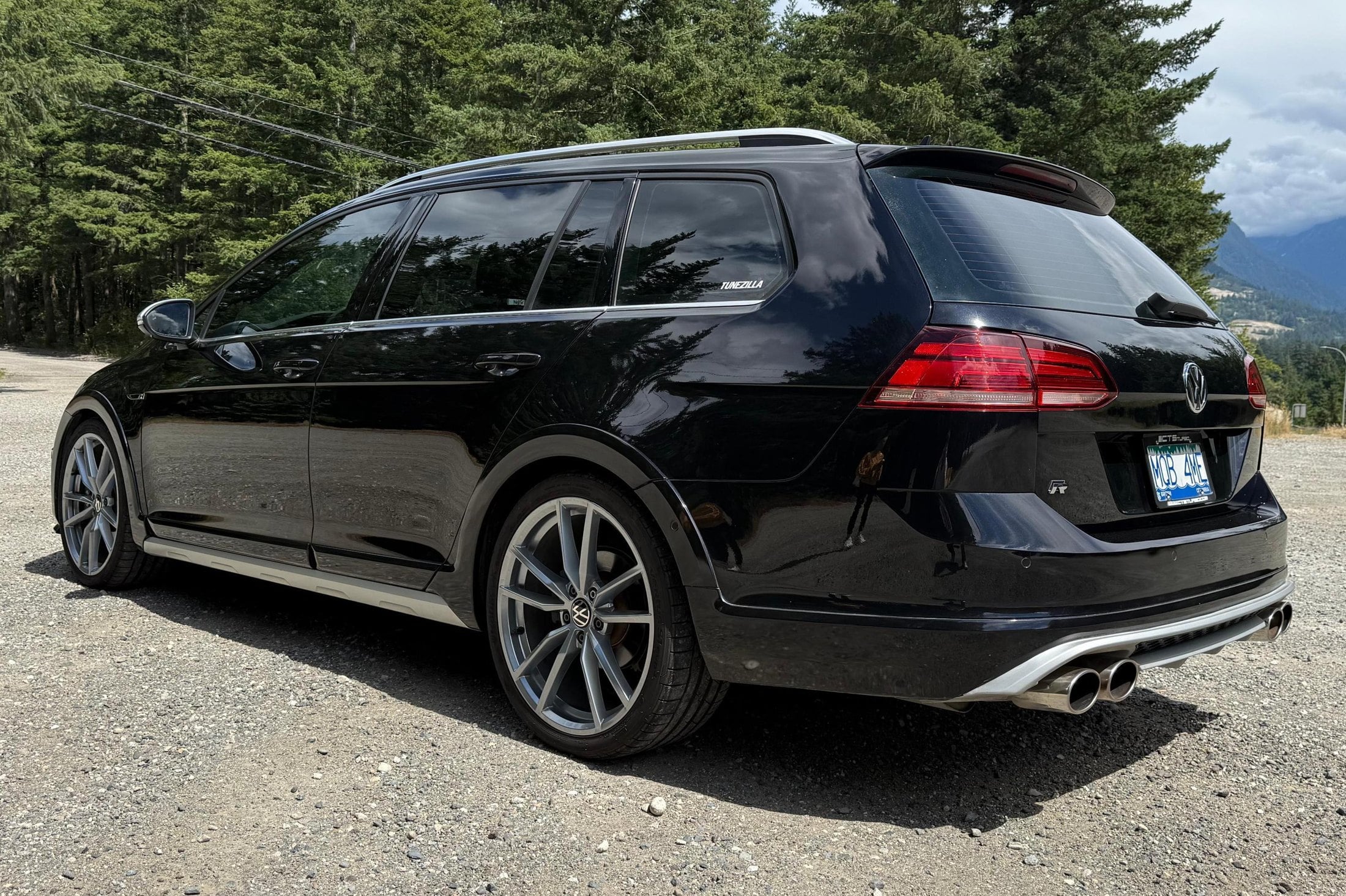 Rear three-quarter of the Deep Black Pearl Alltrack R-wagon with quad exhaust tips and Euro Golf R diffuser
