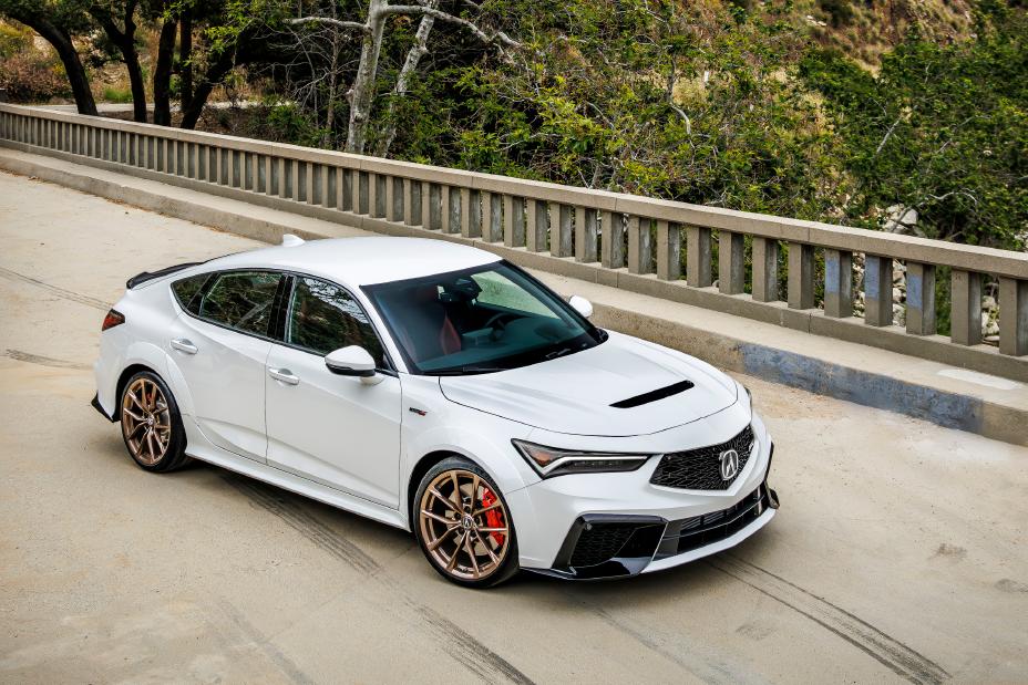 Official Acura photo of a white 2026 Integra Type S, front three-quarter with copper wheels and red Brembo calipers