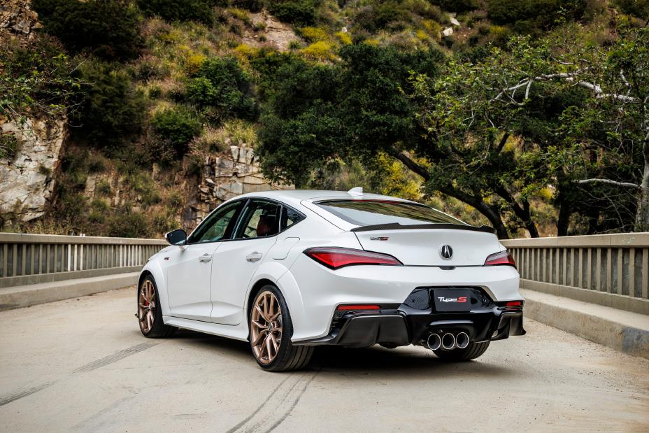 Official Acura photo of a white 2026 Integra Type S rear three-quarter with triple-outlet exhaust