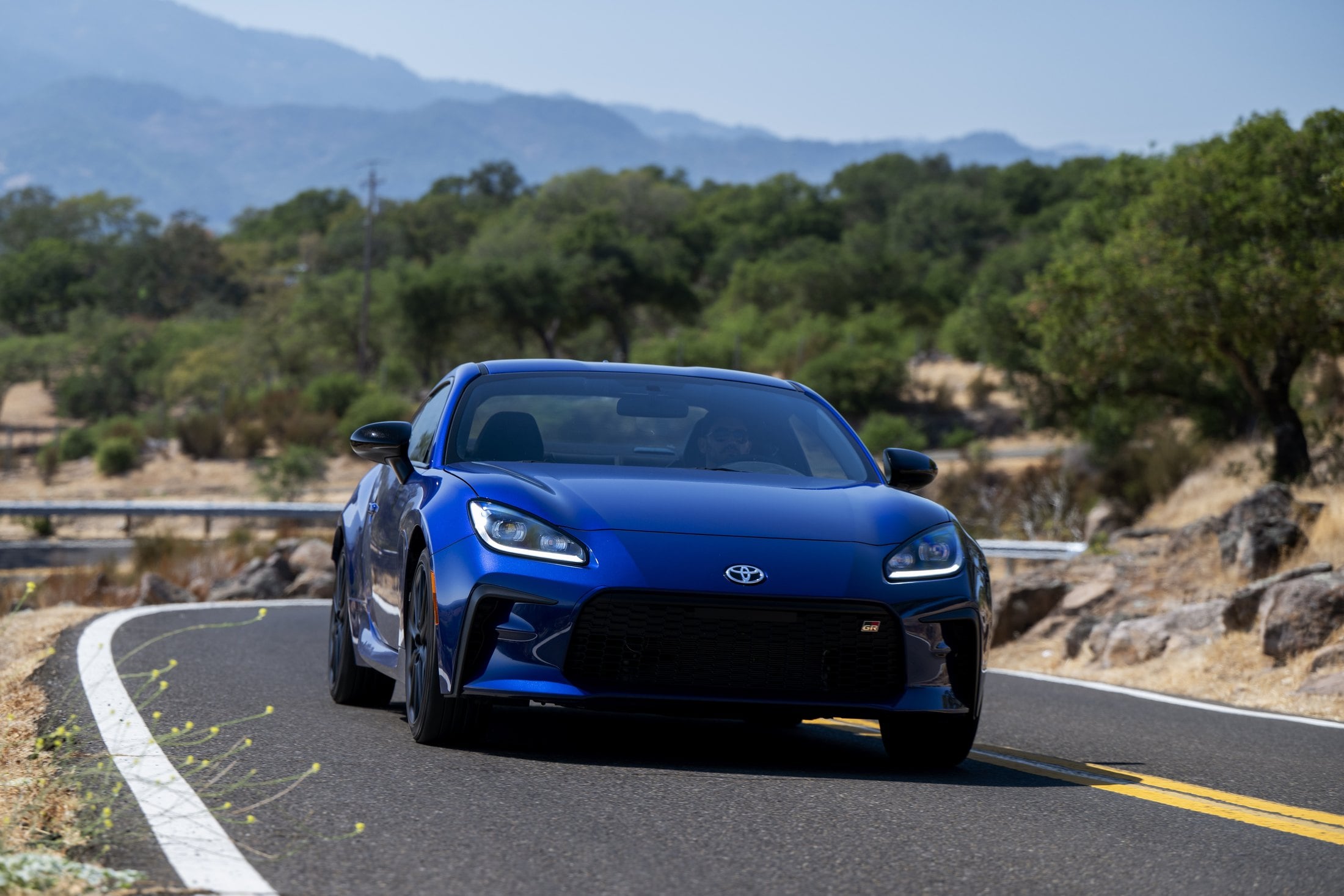 2027 Toyota GR86 Premium Trueno Blue on a mountain road
