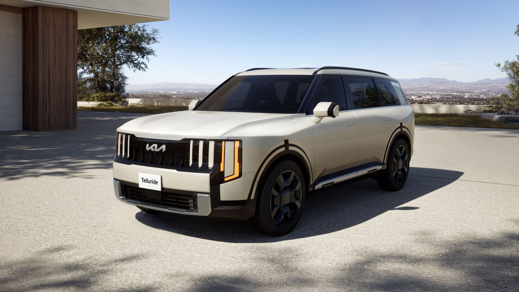 Official Kia press photo of the 2027 Telluride Hybrid, front three-quarter at a house