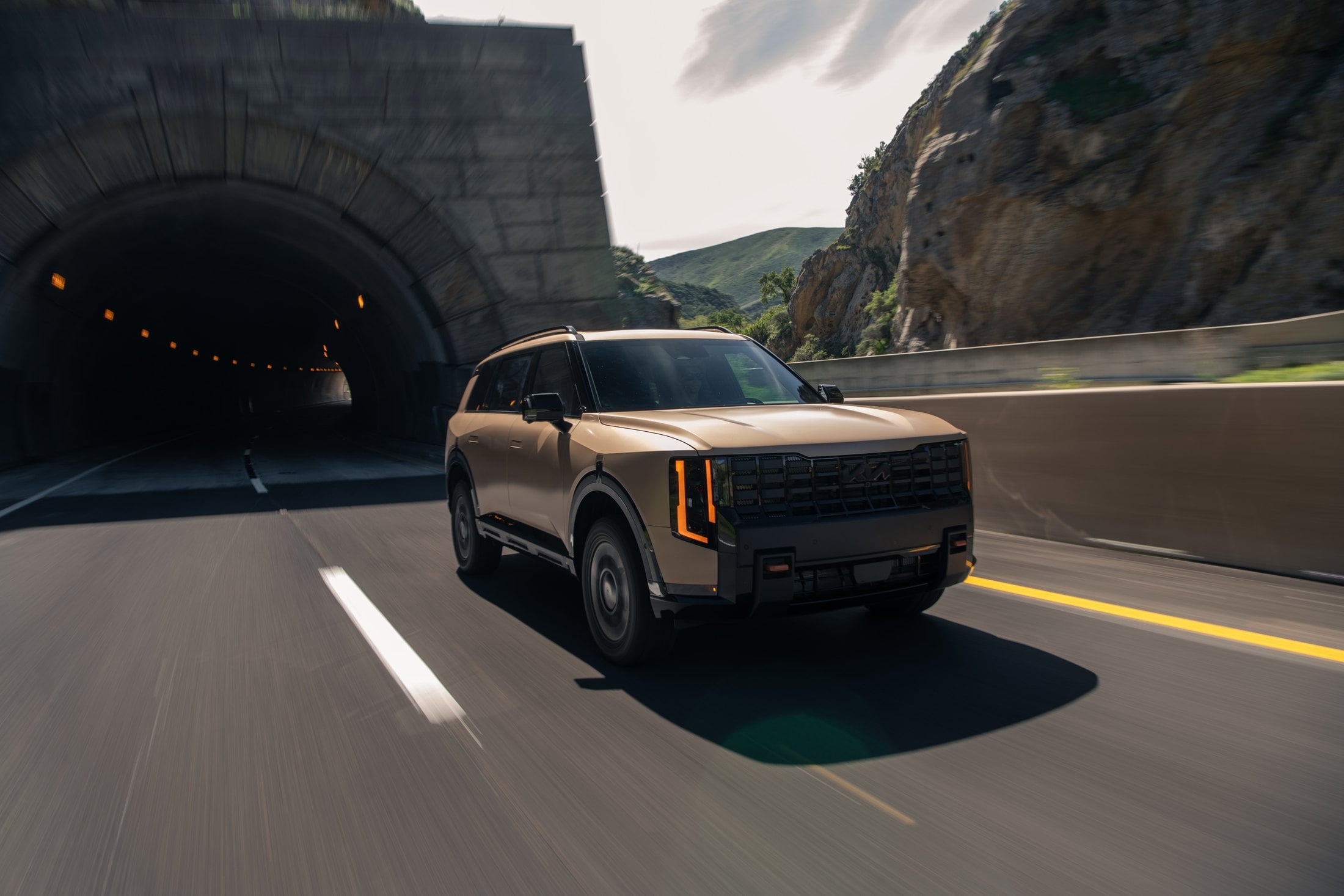 Official Kia press photo of the 2027 Telluride X-Pro driving on a coastal highway