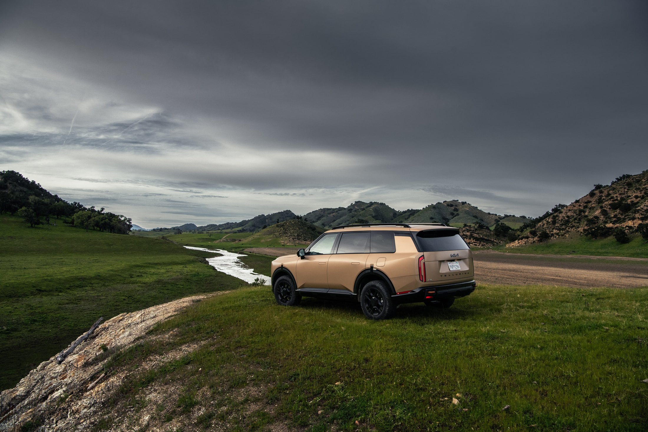 Official Kia press photo of the 2027 Telluride X-Pro, rear three-quarter on a Santa Barbara hillside