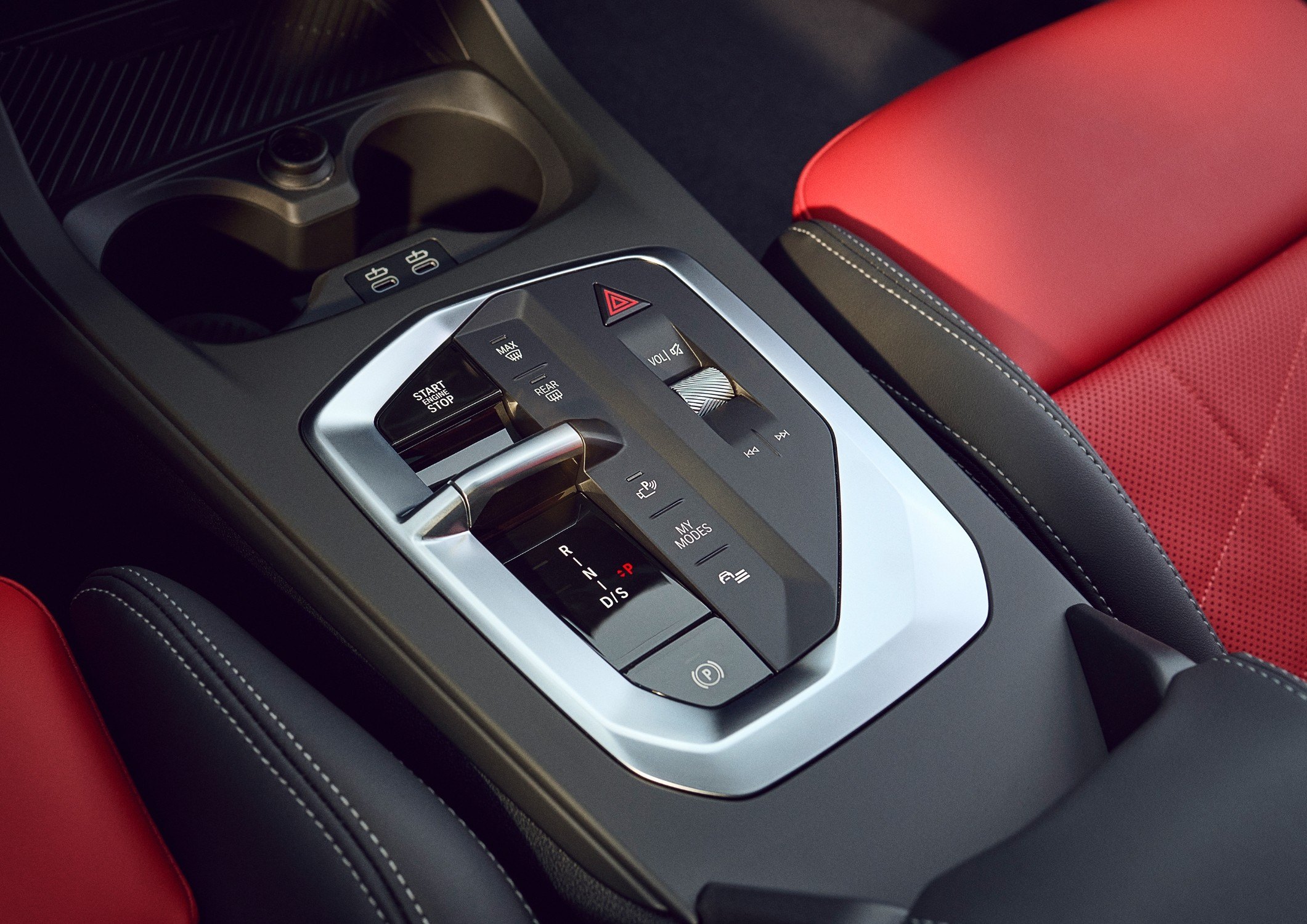 Official BMW press photo of the 2025 M235 xDrive Gran Coupe center console with toggle shifter and red seats