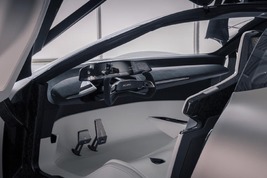 Official photo of the Acura NEXERA Vision concept cockpit through an open butterfly door, yoke and white seats