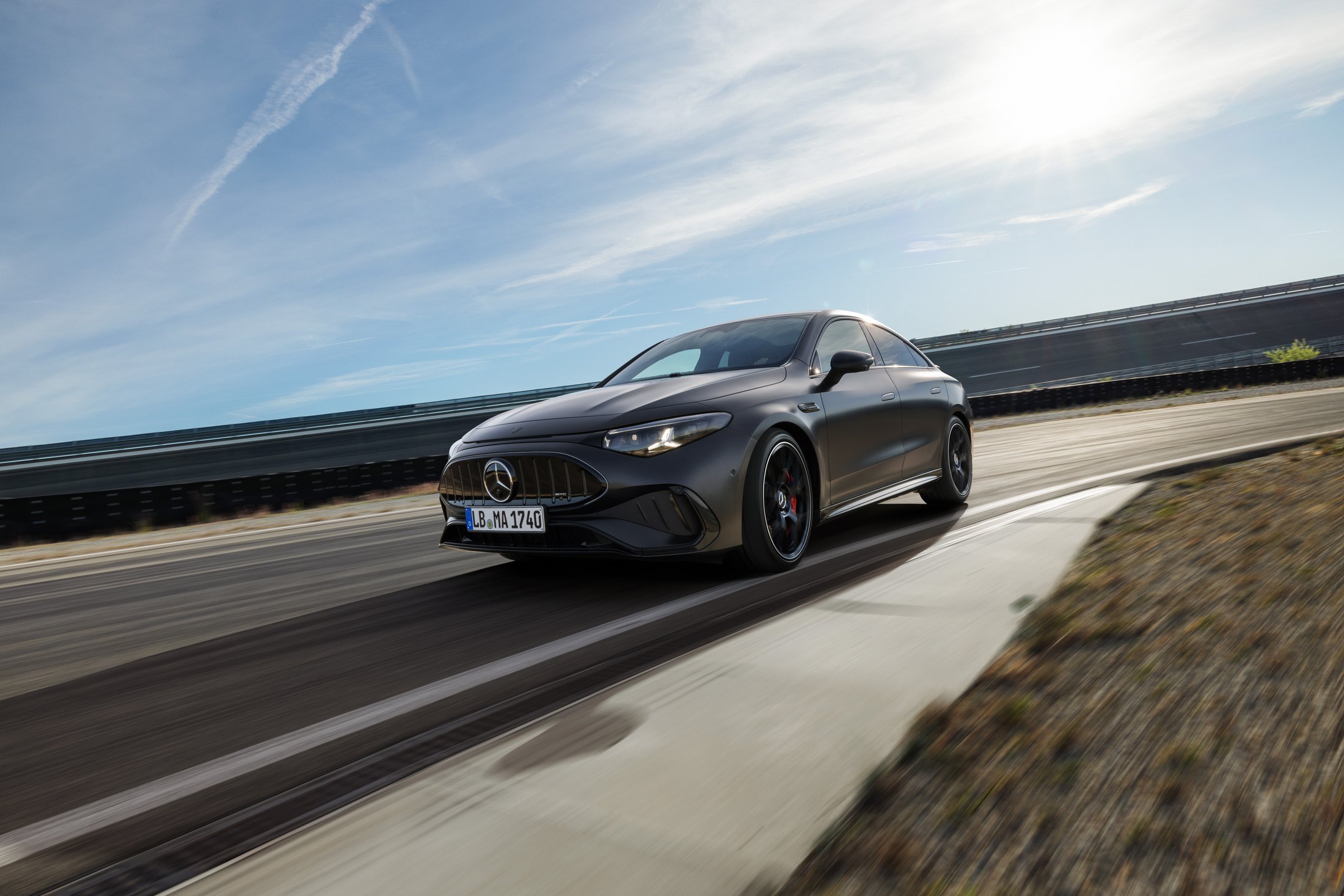 Official Mercedes-AMG photo of the electric CLA 45 4MATIC+ in MANUFAKTUR graphite grey magno, front three-quarter on a test track