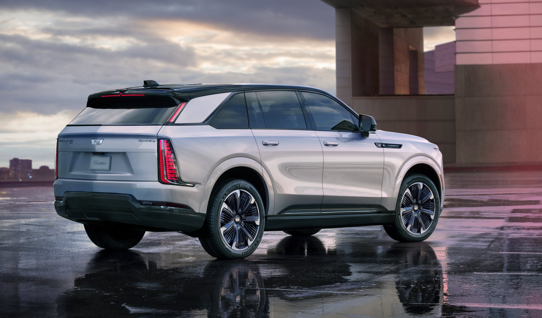 Official Cadillac photo of the 2026 Escalade IQ rear three-quarter with vertical taillights