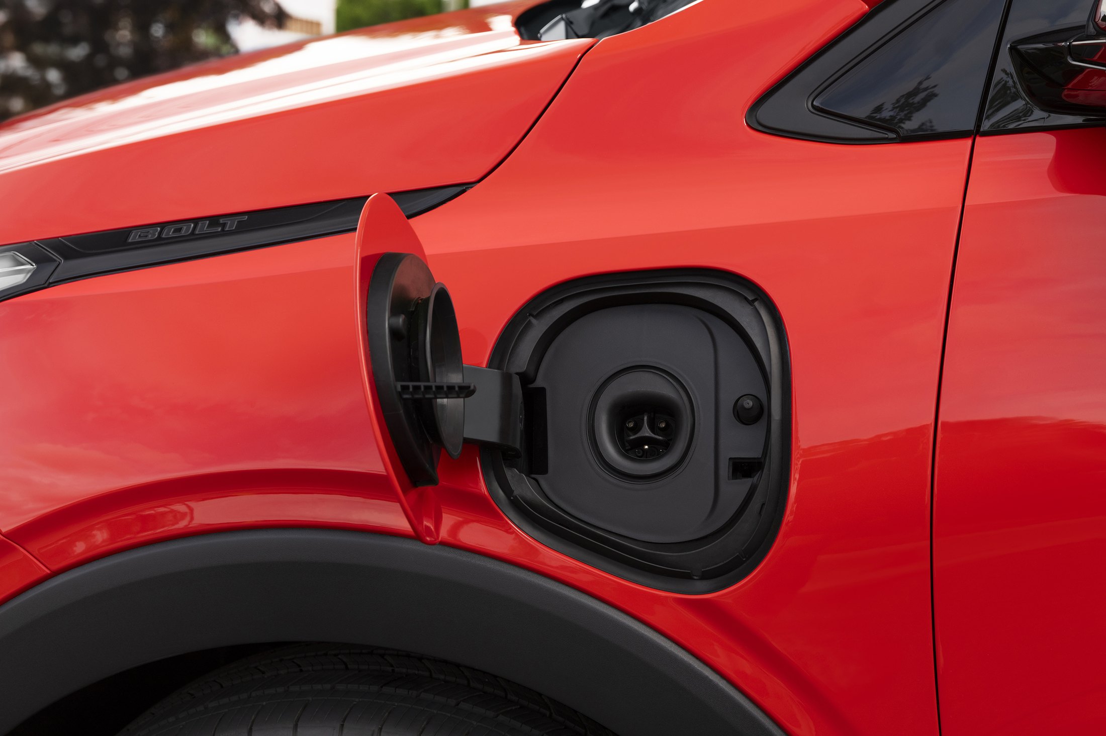 Official Chevrolet photo of the 2027 Bolt native NACS charging port on the front fender