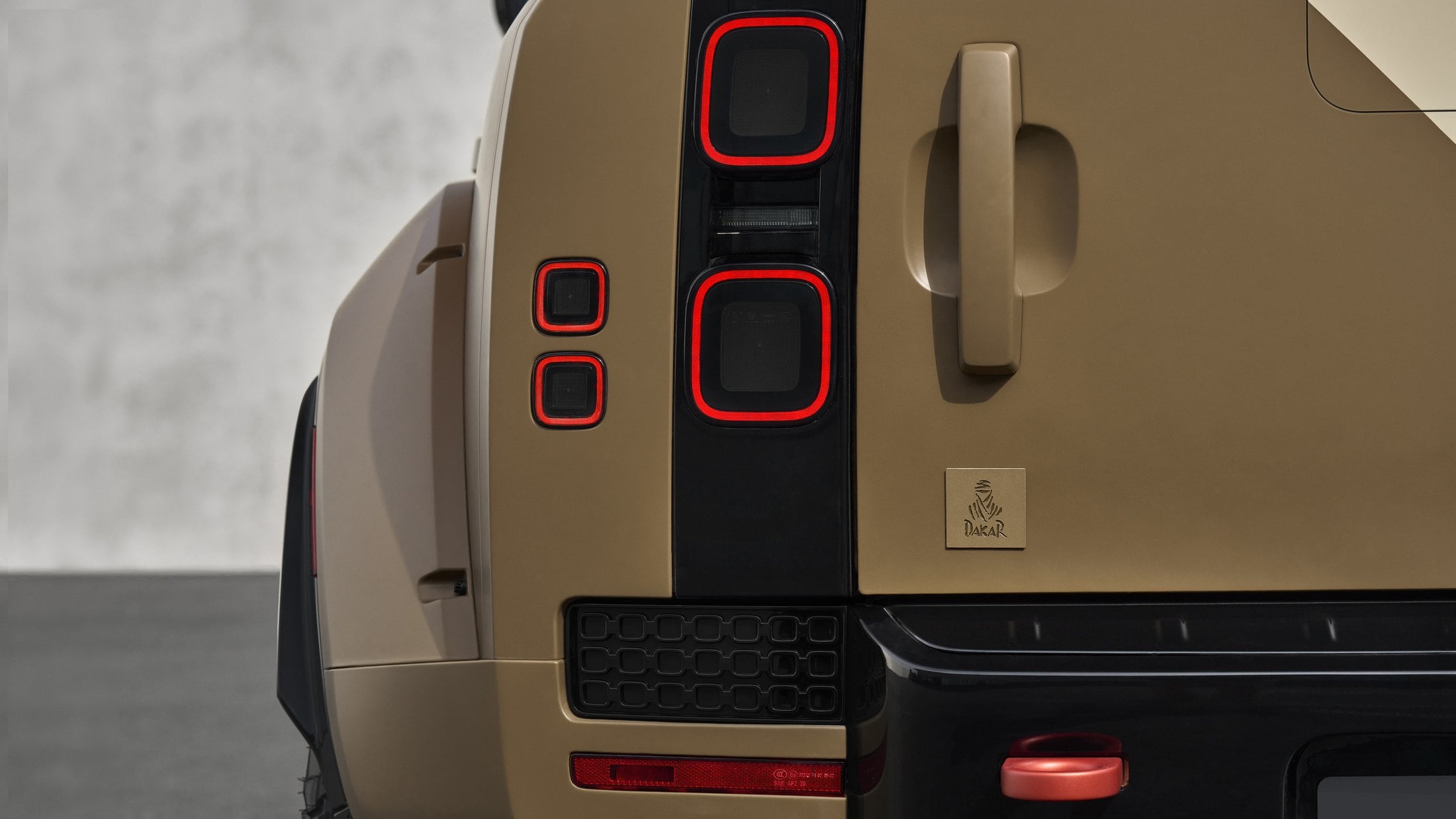 Official photo of the Defender Dakar rear corner with Dakar Rally emblem and LED tail lamps