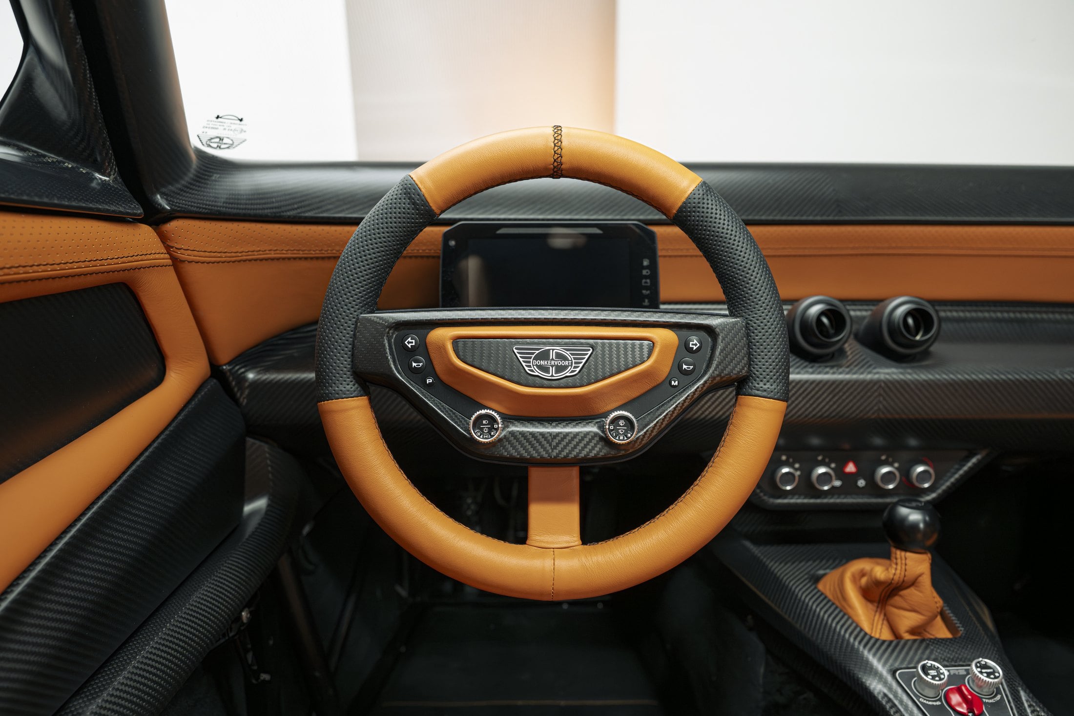 Official Donkervoort studio photo of the P24 RS cockpit, removable steering wheel and five-speed shifter