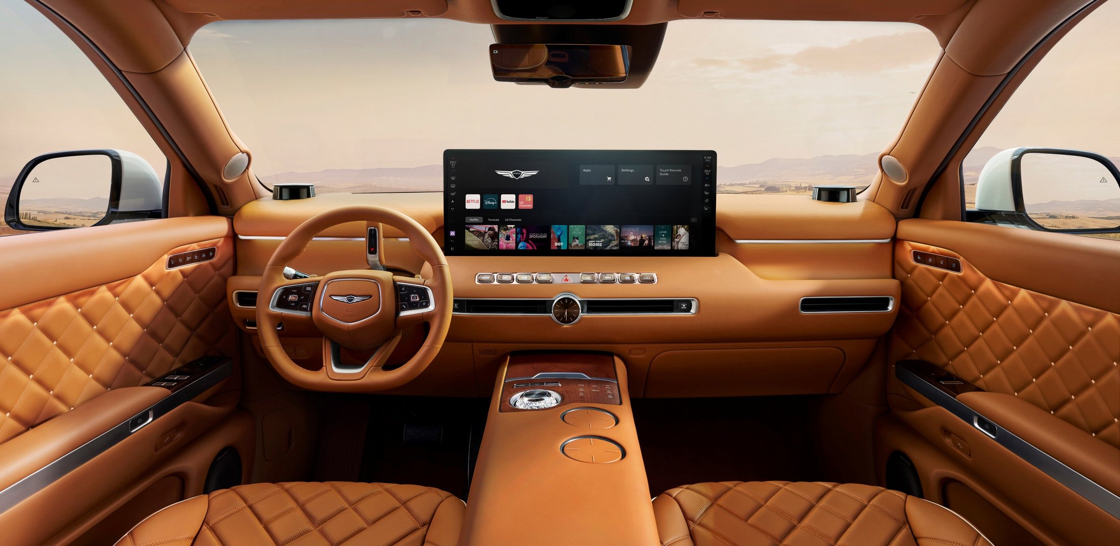 Genesis GV90 cabin looking forward at the pop-up OLED Cinematic Display and steering wheel