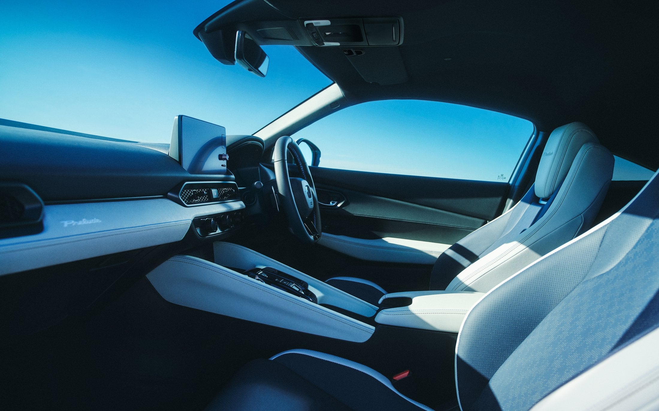 Official Honda photo of the 2026 Prelude cabin, two-tone sport seats and a Prelude script on the dash