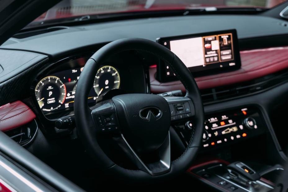 Official Infiniti photo of the 2027 QX65 cockpit: steering wheel, digital cluster, and 12.3-inch center screen