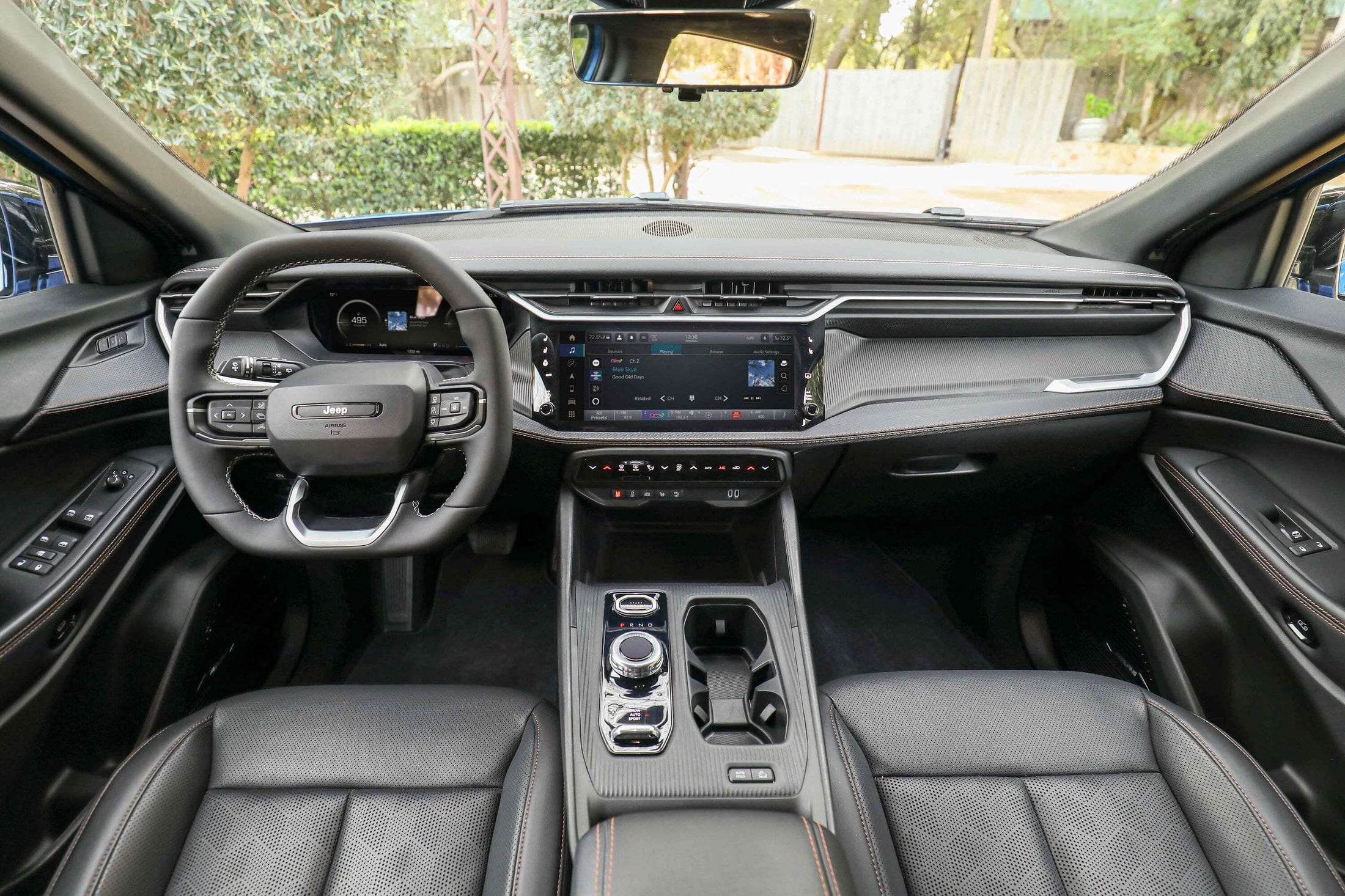 Official Jeep photo of the 2026 Cherokee cabin with a 12.3-inch screen, 10.25-inch cluster, and rotary shifter