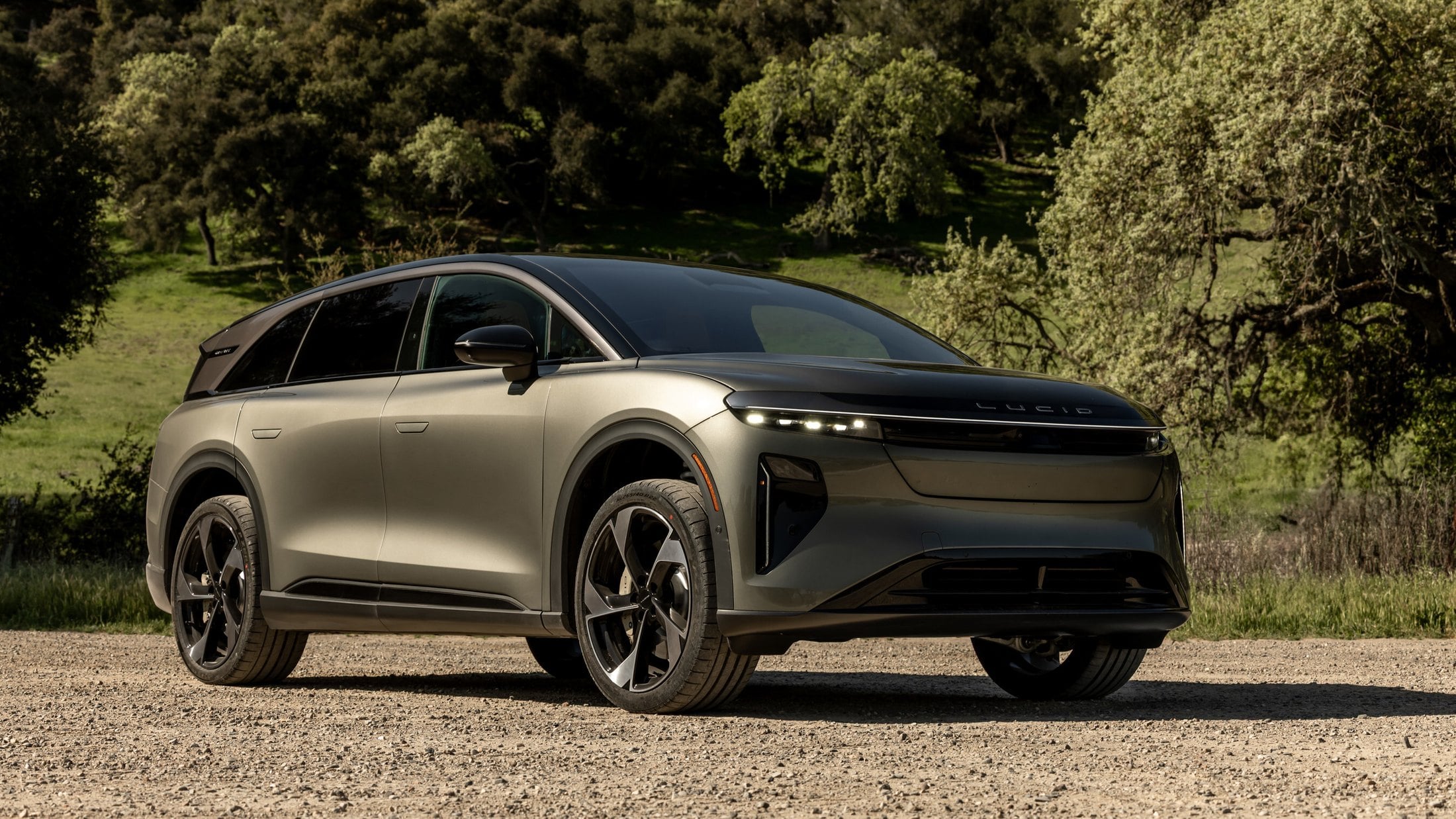 Lucid Gravity Grand Touring front three-quarter on a dirt path