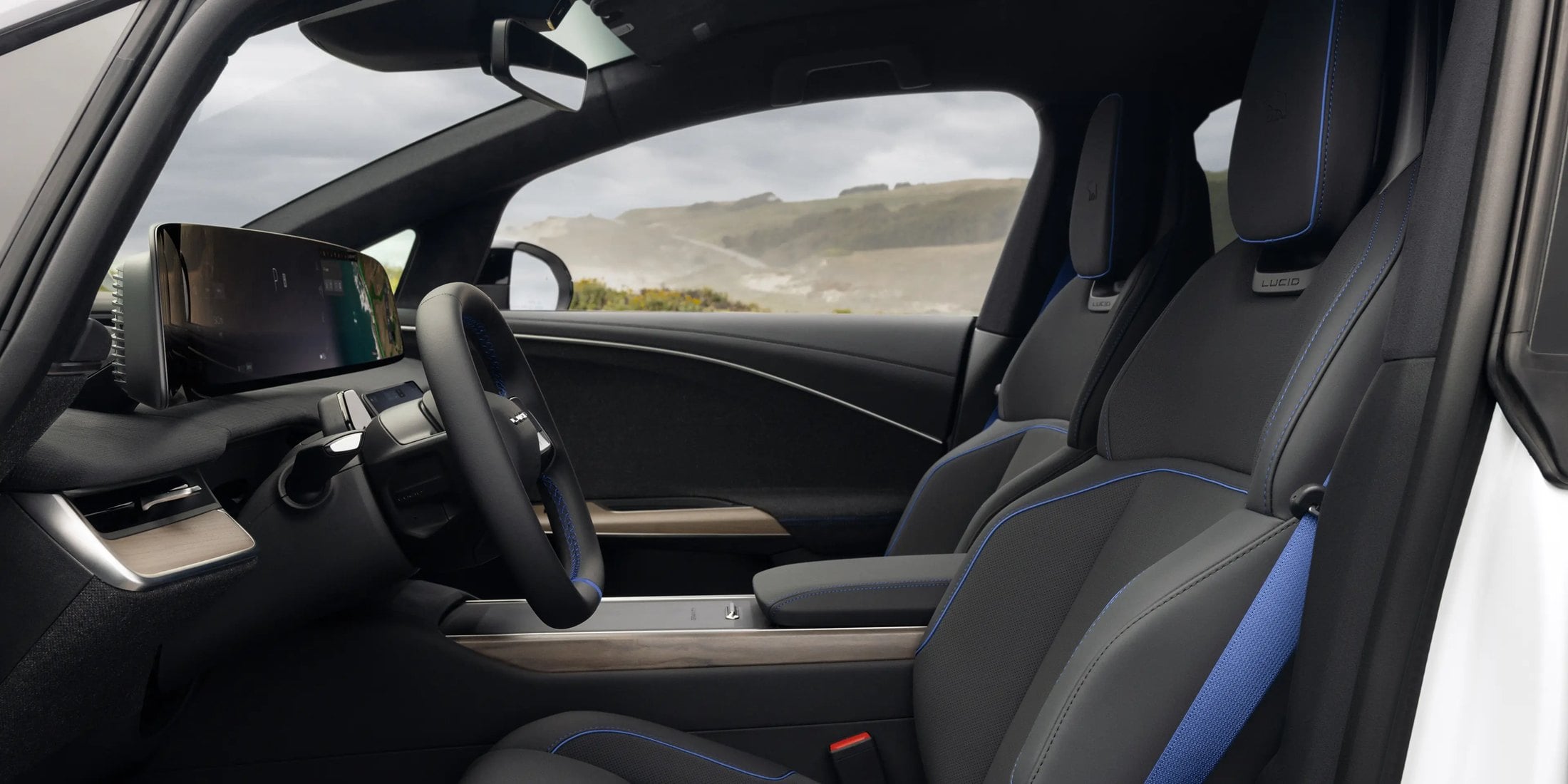 Official Lucid photo of the Gravity GT-S cabin with blue seatbelts, blue stitching, and Clearview Cockpit