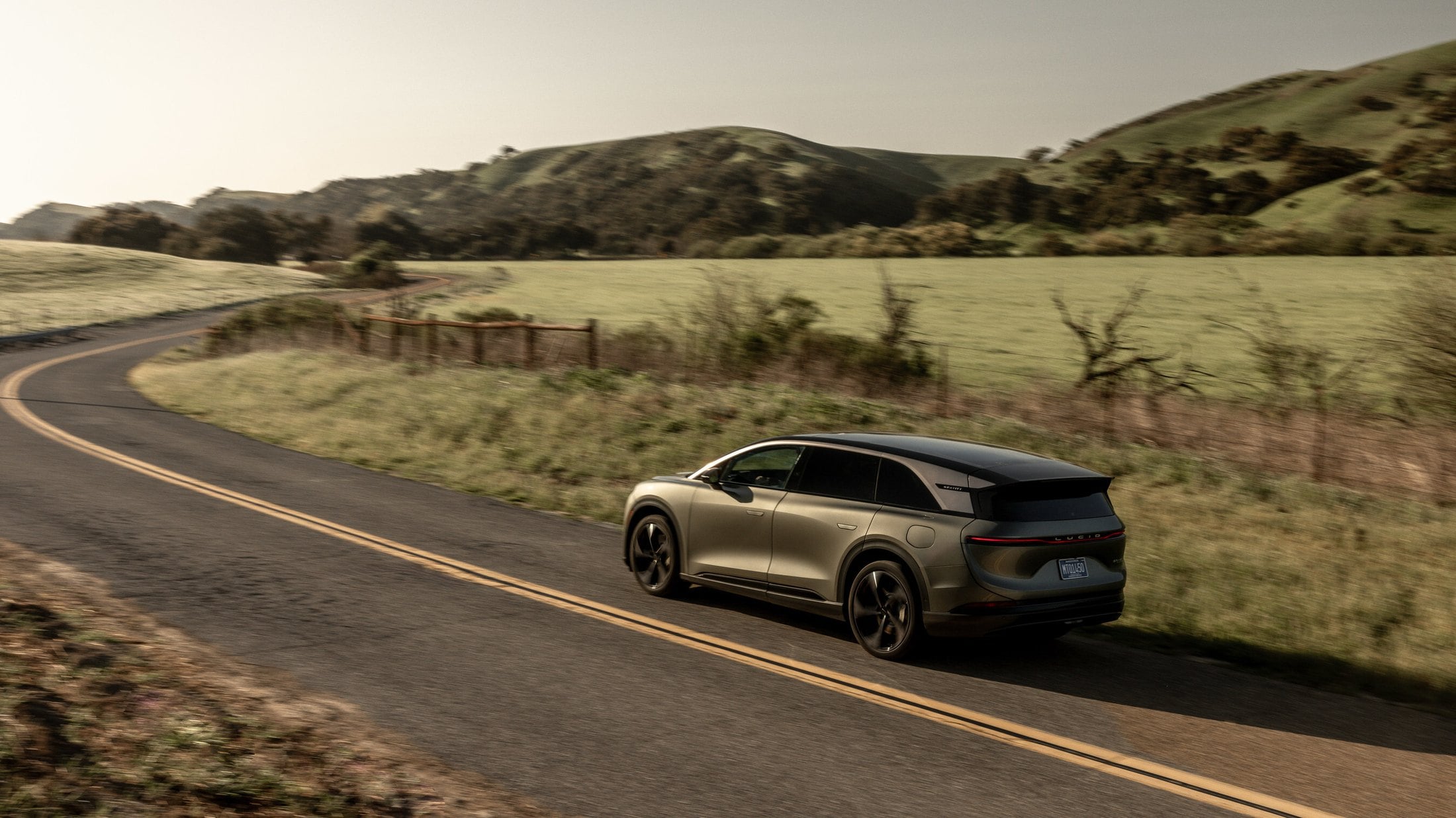Lucid Gravity rear three-quarter on a winding road