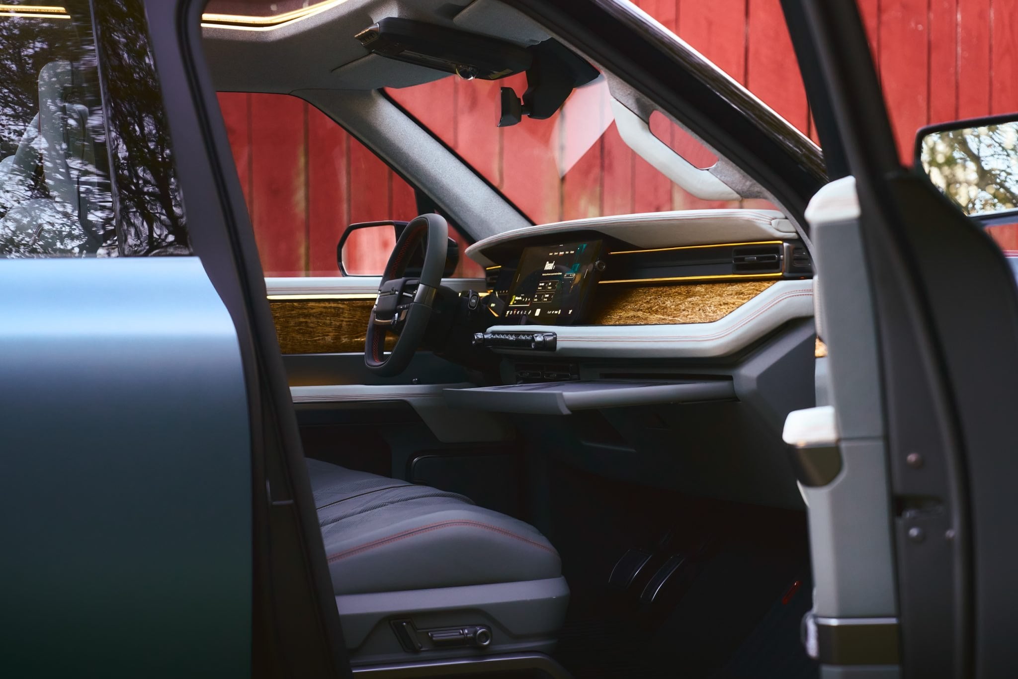 Official Scout Motors photo of the Terra cabin with physical switches, wood trim, and a wide screen