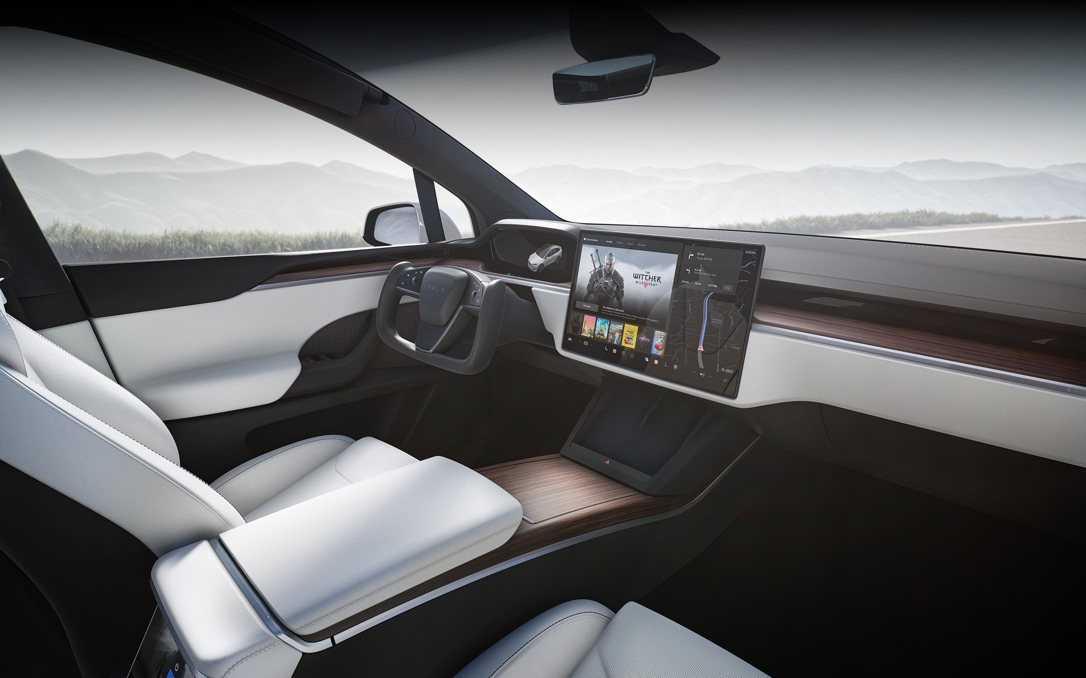 Official Tesla photo of a Model X cabin with white seats, a yoke, and the panoramic windshield