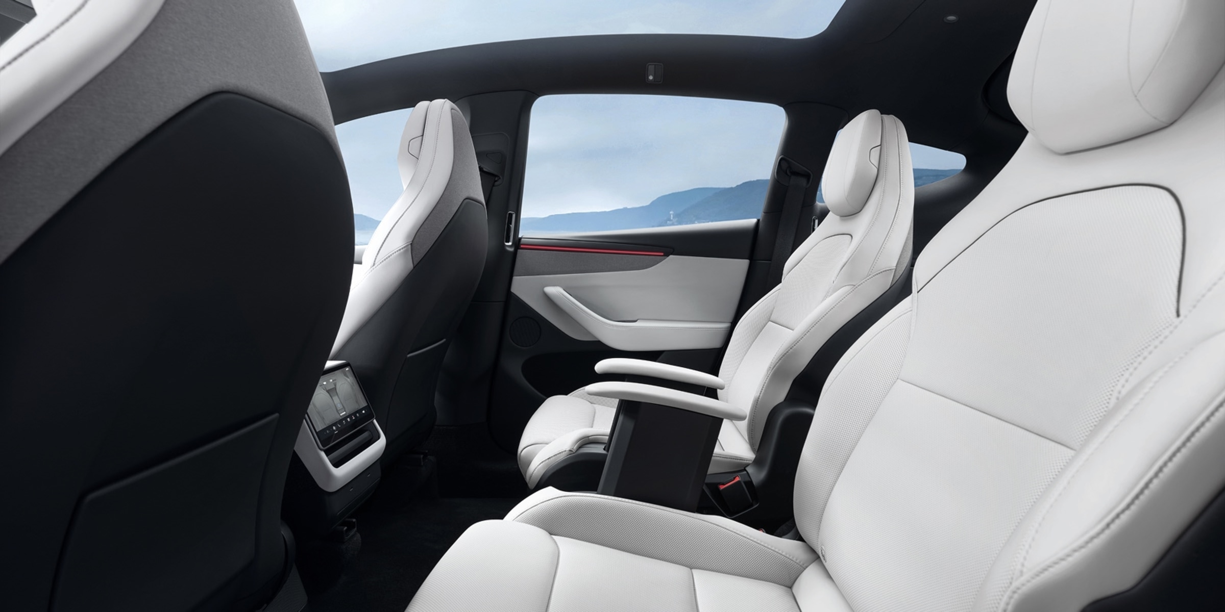 Official Tesla photo of Model Y L second-row captain's chairs and rear touchscreen