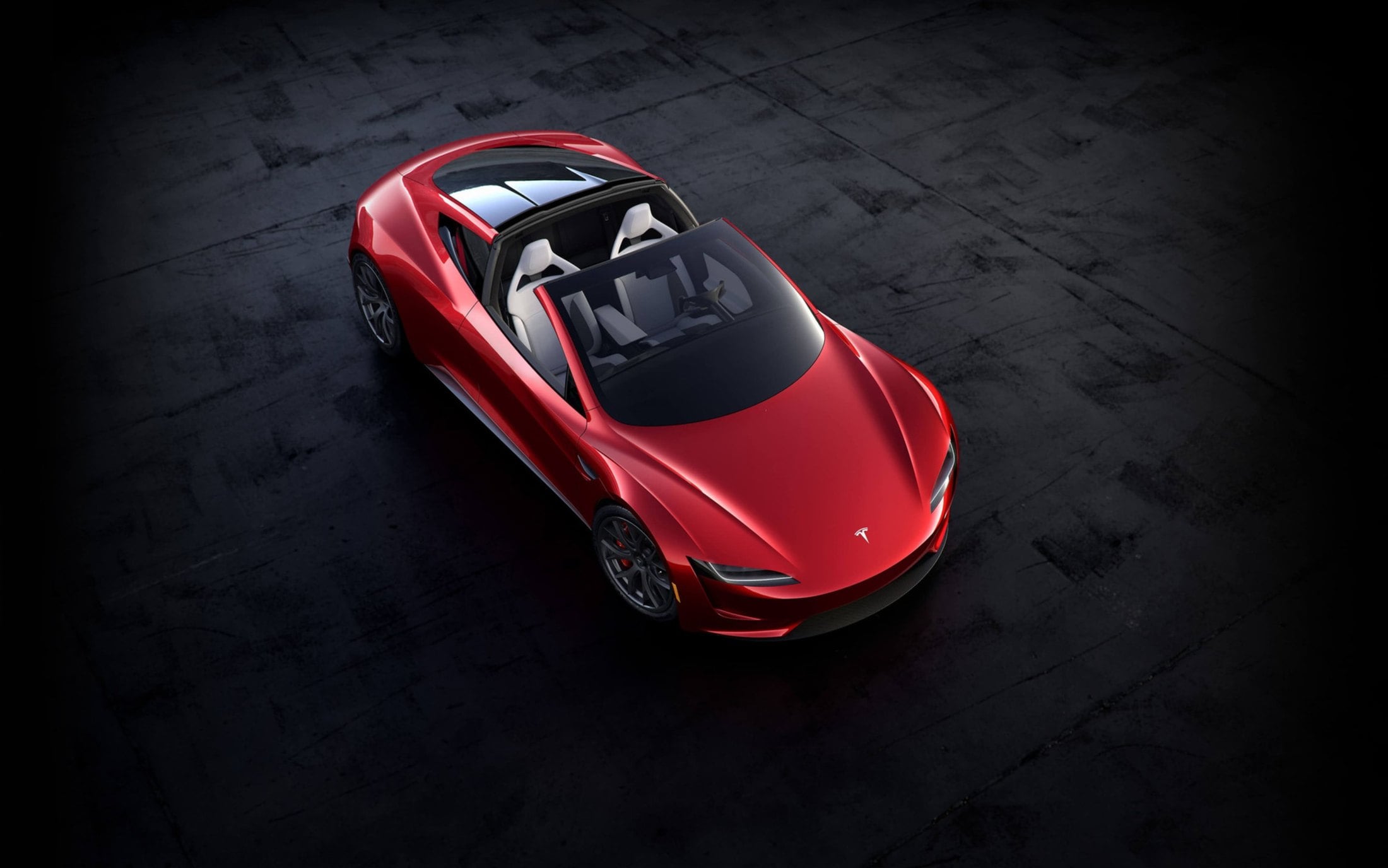 Overhead official Tesla photo of the red next-generation Roadster with glass roof panels removed