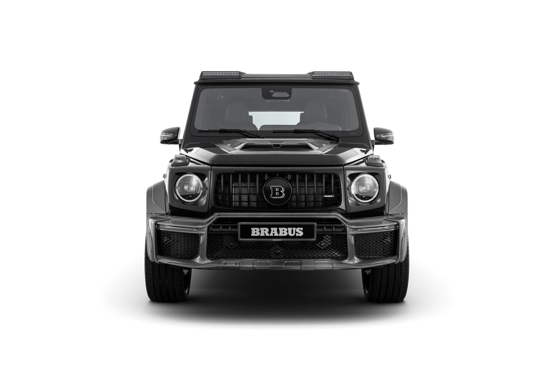Official BRABUS studio photo of a black Mercedes-AMG G 63 WIDESTAR front view with BRABUS grille badge