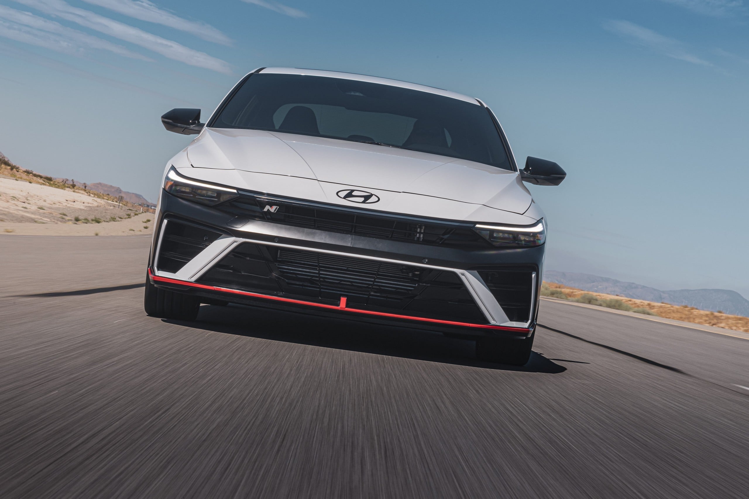 Official Hyundai photo of a white 2026 Elantra N head-on on a desert track