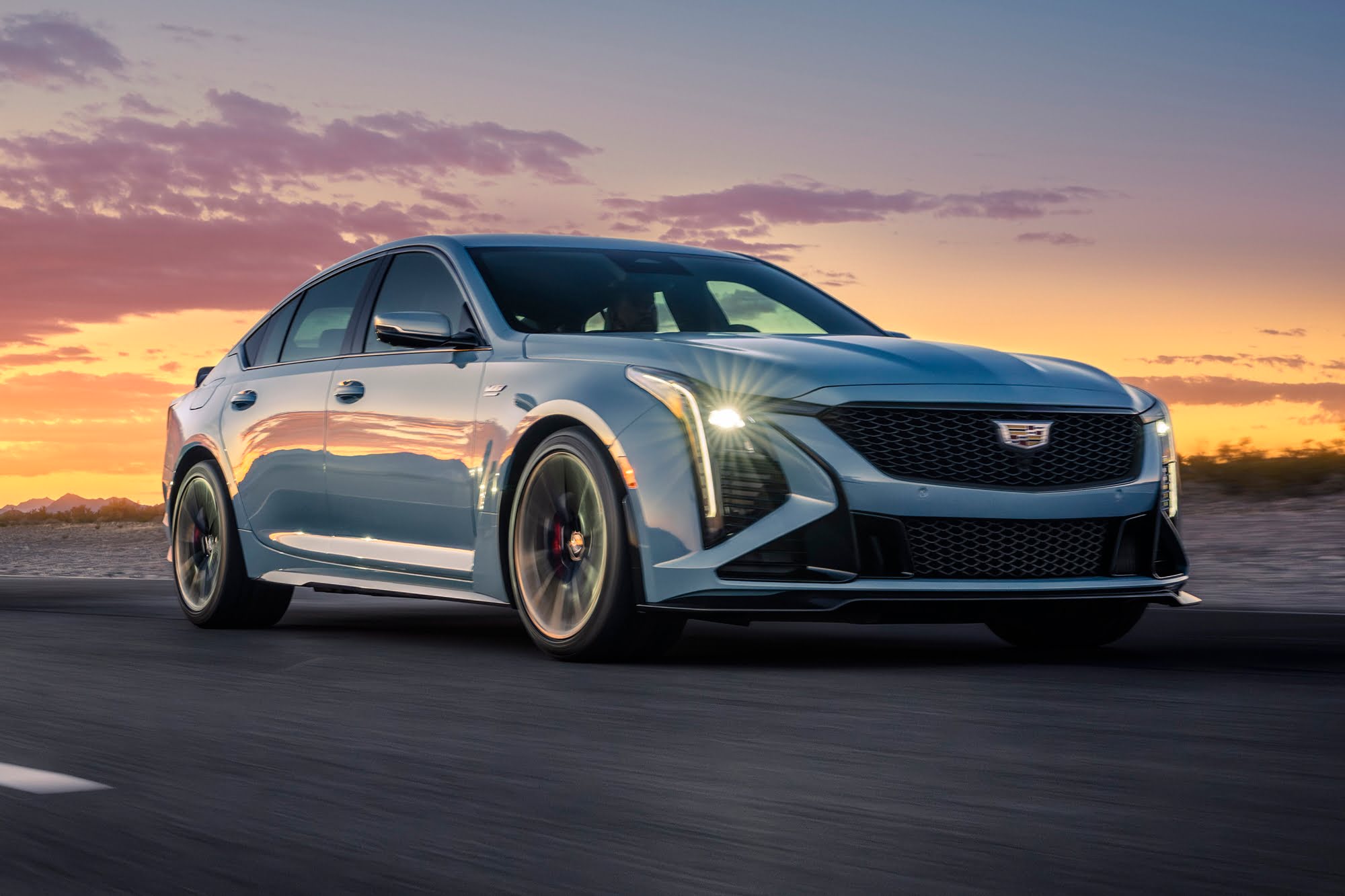 Official Cadillac photo of a CT5-V Blackwing driving front three-quarter on a track