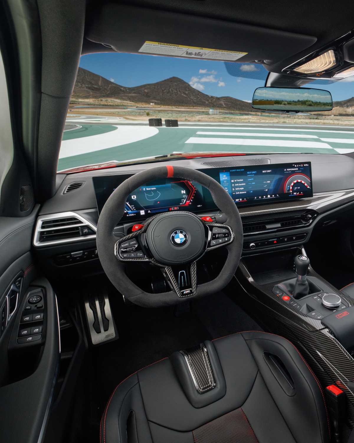 Official BMW photo of the 2027 M3 CS Handschalter driver view with stick and clutch pedals