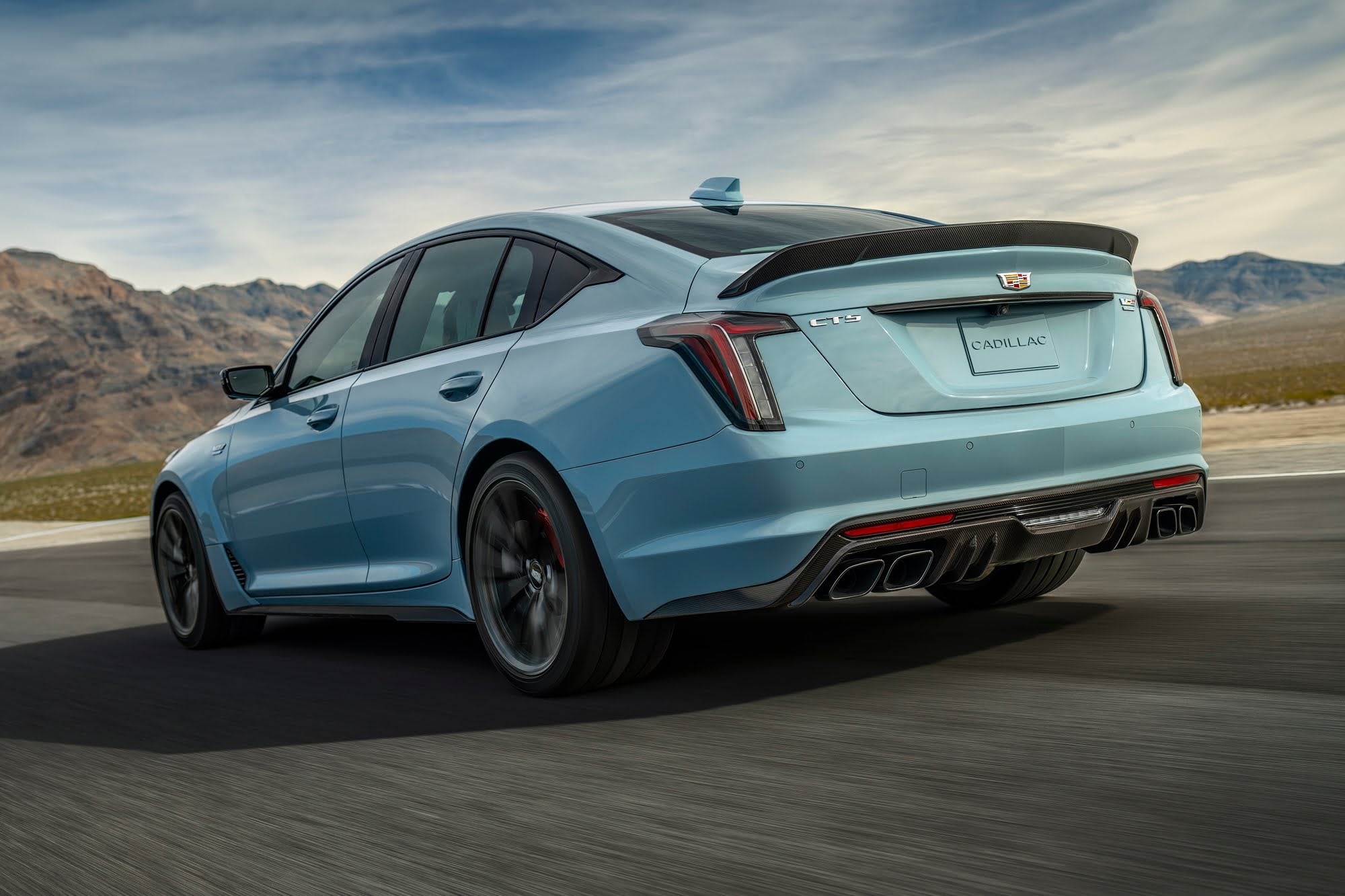 Official Cadillac photo of a CT5-V Blackwing rear three-quarter with quad exhaust and vertical taillights