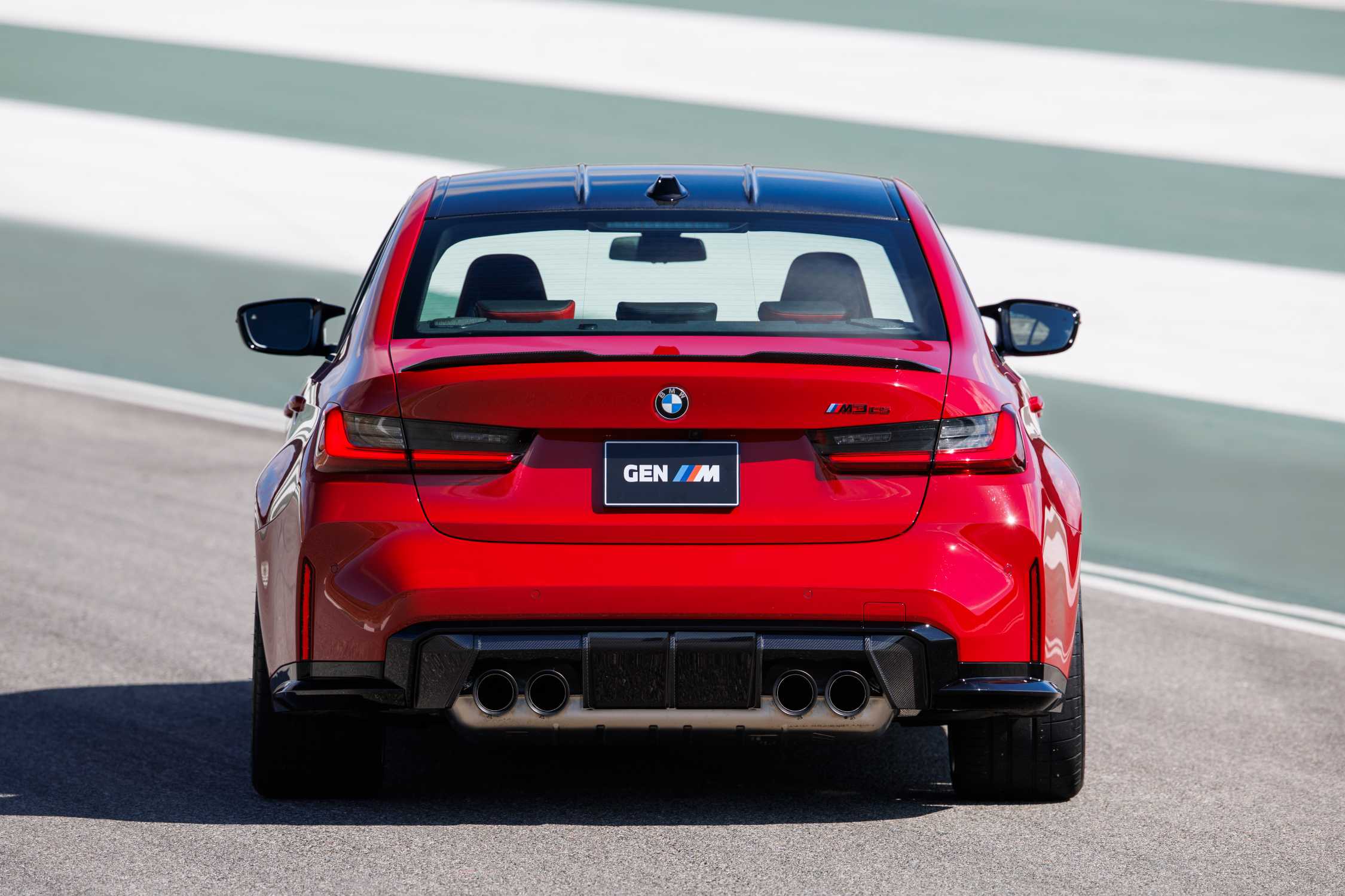Official BMW photo of a 2027 M3 CS Handschalter rear with carbon diffuser and titanium quad exhaust