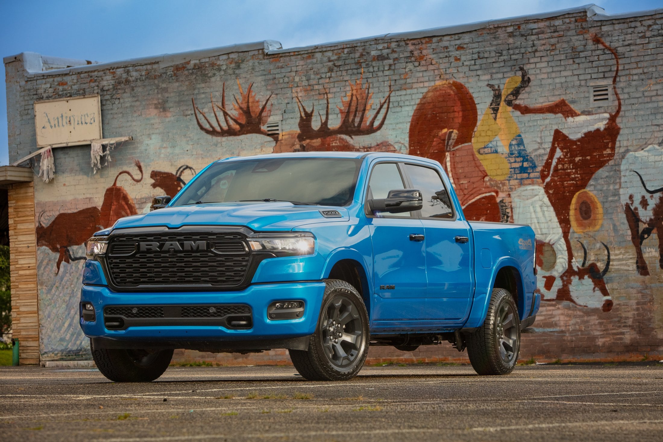 Official RAM photo of a 2026 Ram 1500 Lone Star, front three-quarter in bright blue in front of a mural
