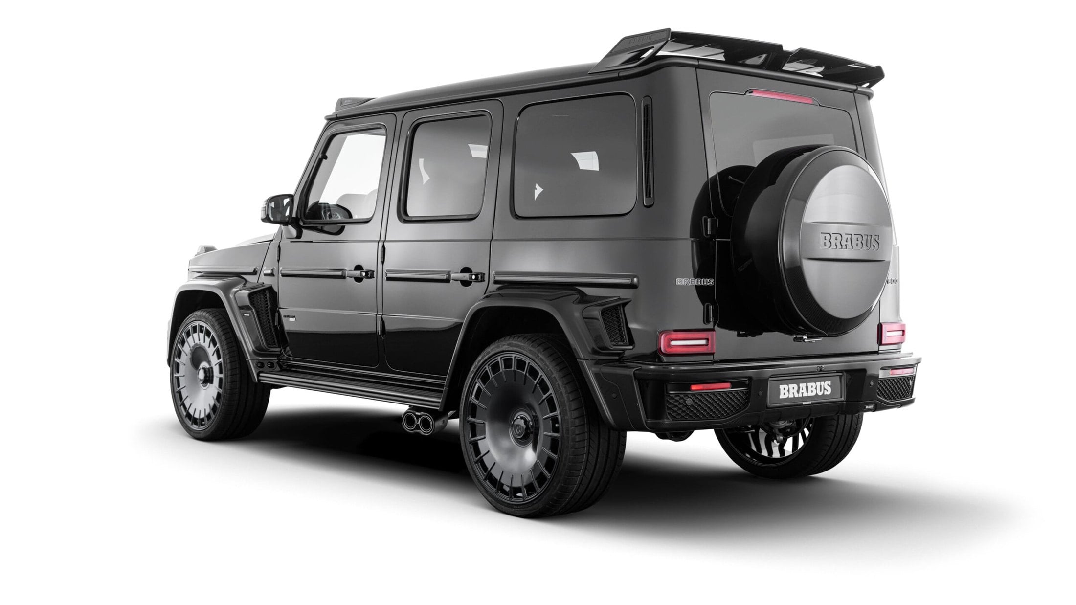 Official BRABUS studio photo of a black Mercedes-AMG G 63 WIDESTAR rear three-quarter with Monoblock wheels
