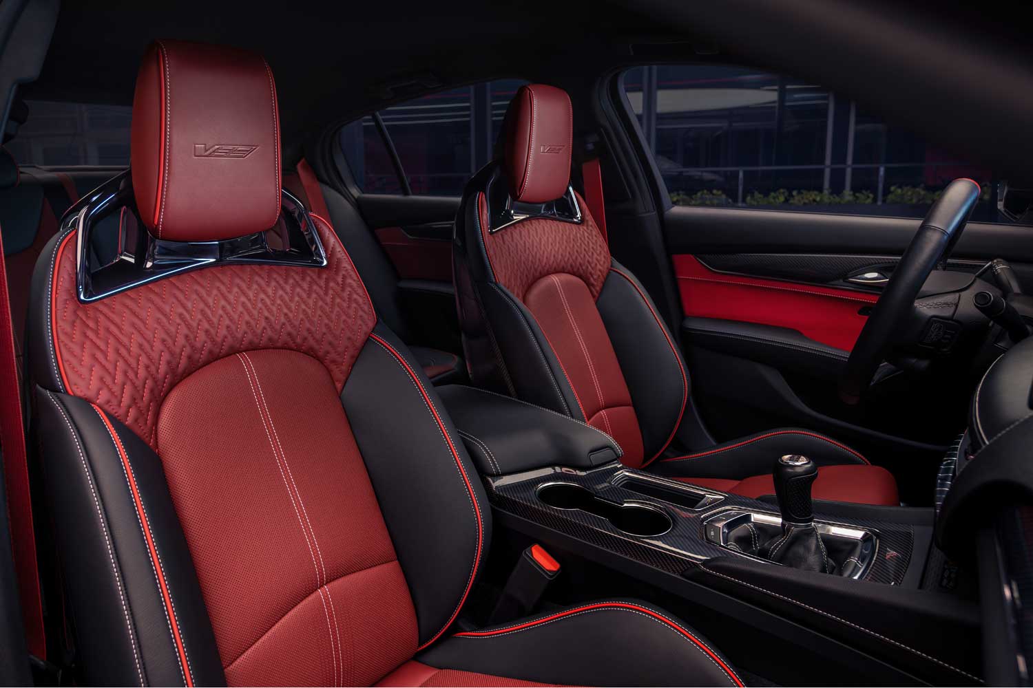 Official Cadillac photo of the CT5-V Blackwing six-speed manual shifter on a carbon-fiber console between quilted performance seats