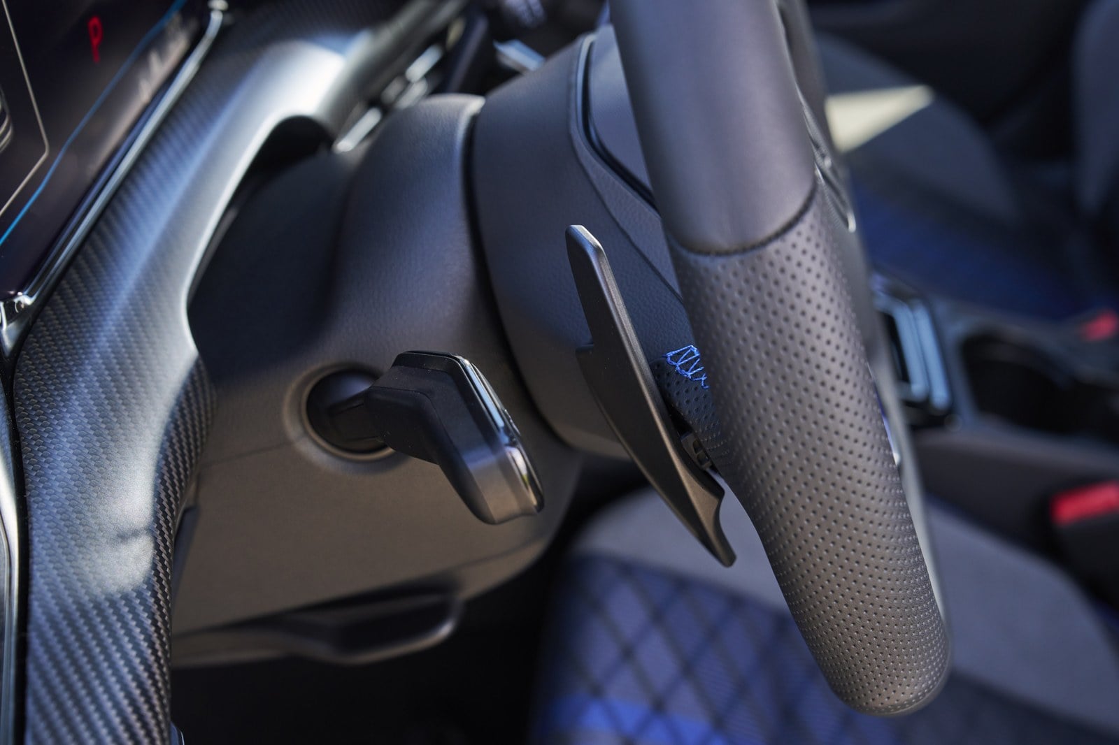 Official Volkswagen photo of Golf R steering wheel paddle shifter and carbon-fiber dash trim