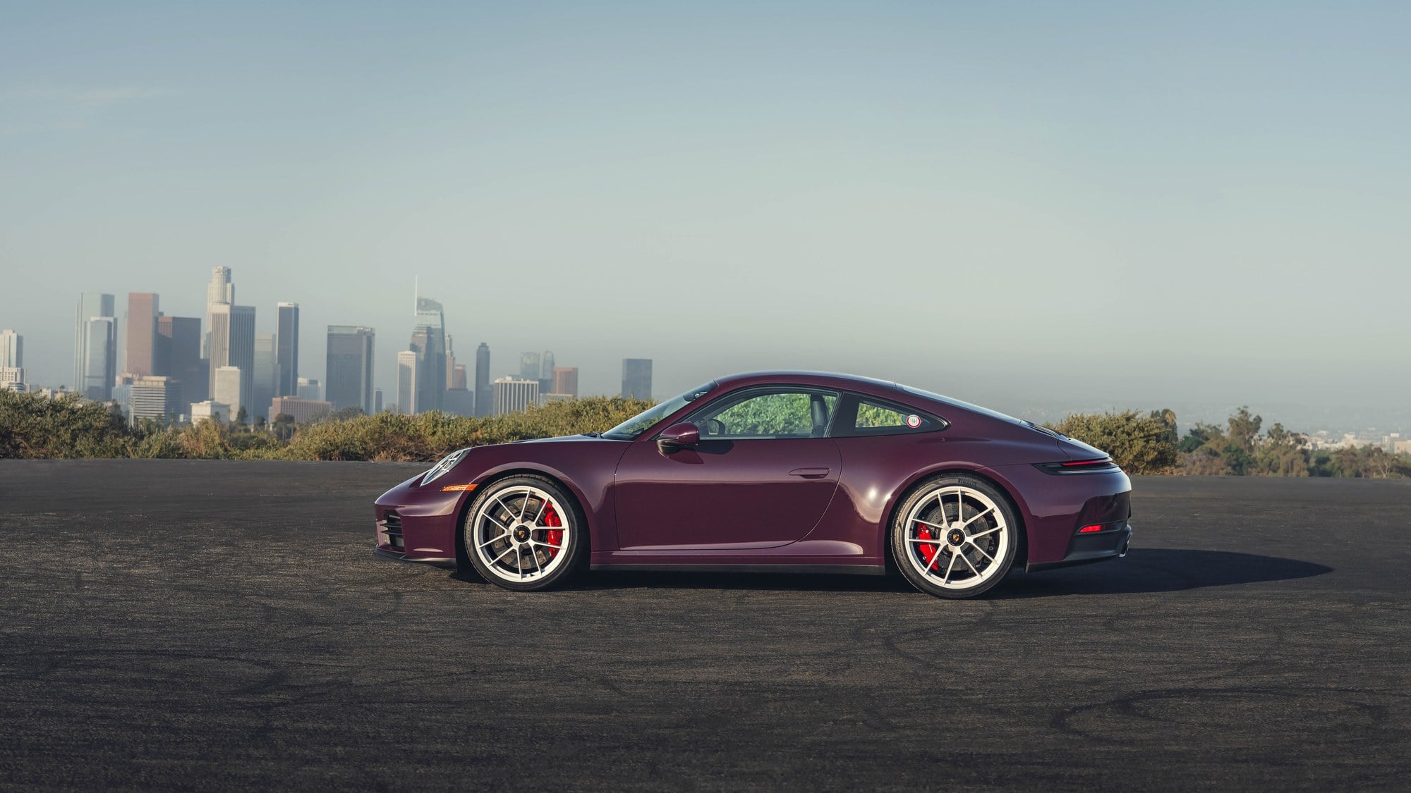 Official Porsche photo of aubergine 2027 911 Carrera S with MT Package side profile with center-lock wheels