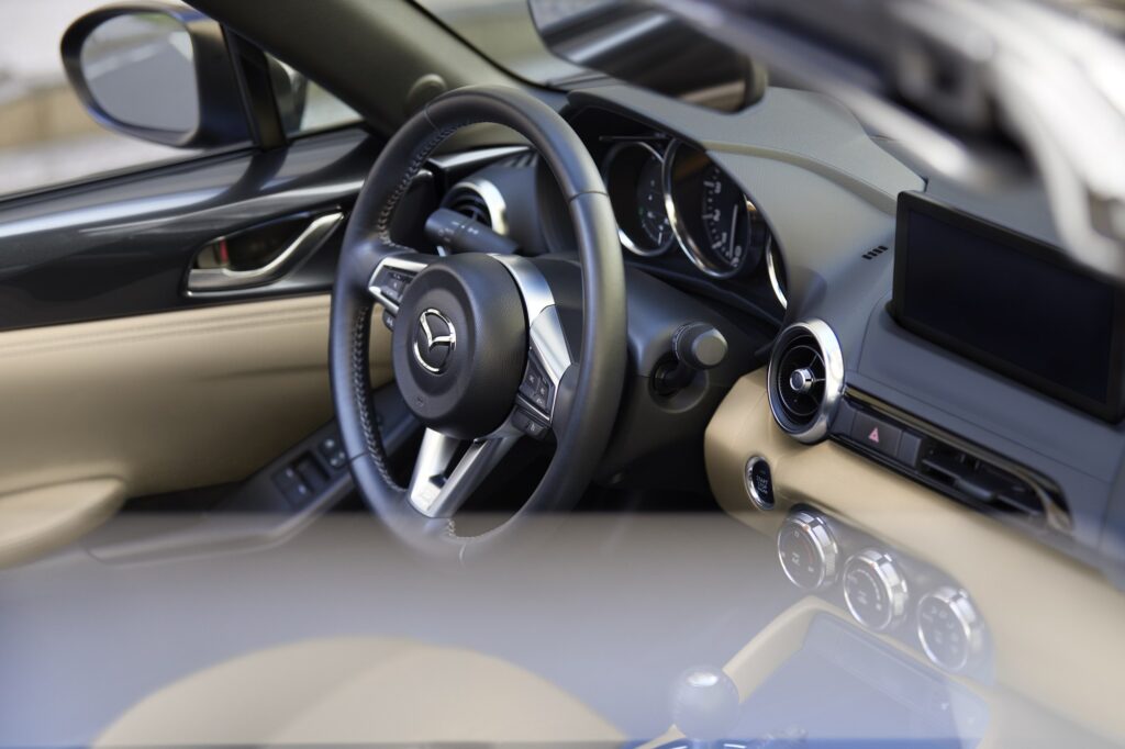 Official Mazda photo of 2026 MX-5 Miata cabin with six-speed manual shifter and tan interior