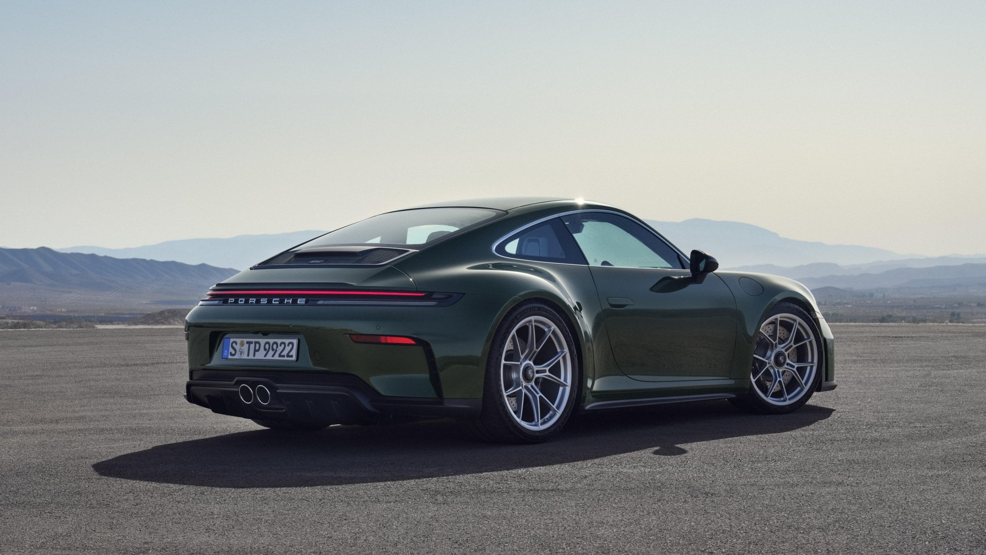 Official Porsche photo of a 2026 911 GT3 with Touring Package rear three-quarter in forest green
