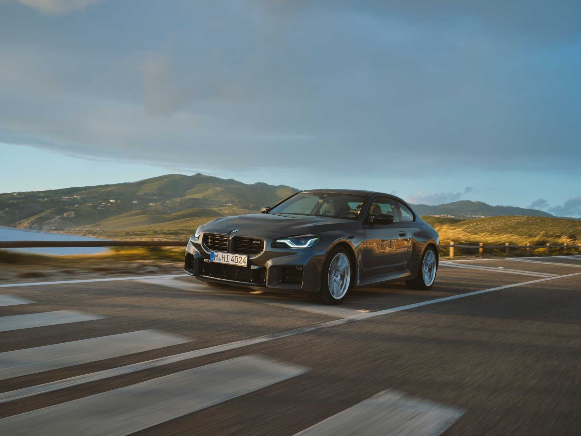Official BMW photo of a grey BMW M2 Coupe front three-quarter on a coastal road