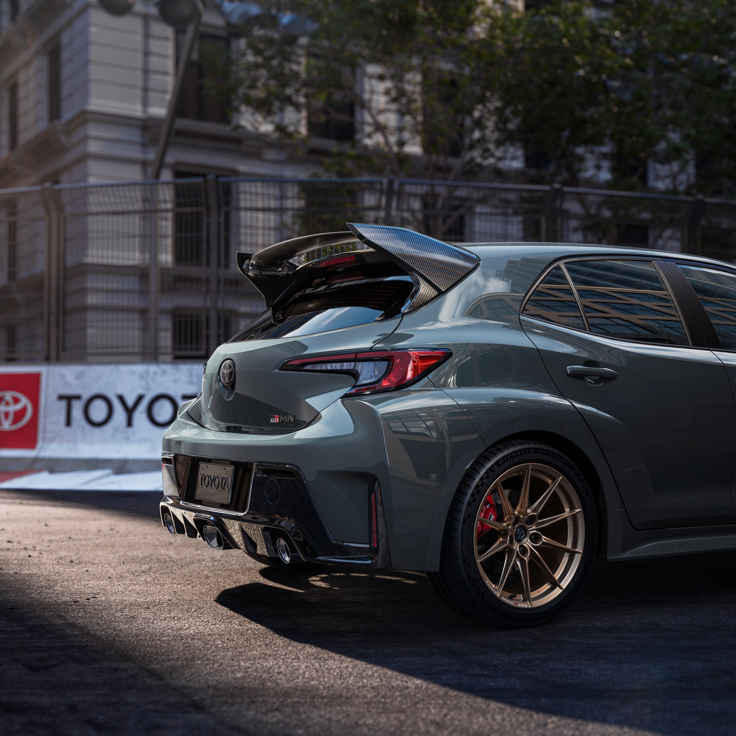 Official Toyota photo of 2026 GRMN Corolla rear three-quarter with GRMN badge and triple exhaust