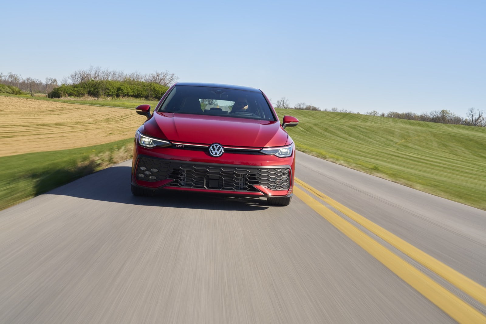 Official VW photo of 2025/2026 Golf GTI Autobahn rolling toward camera in Kings Red Metallic