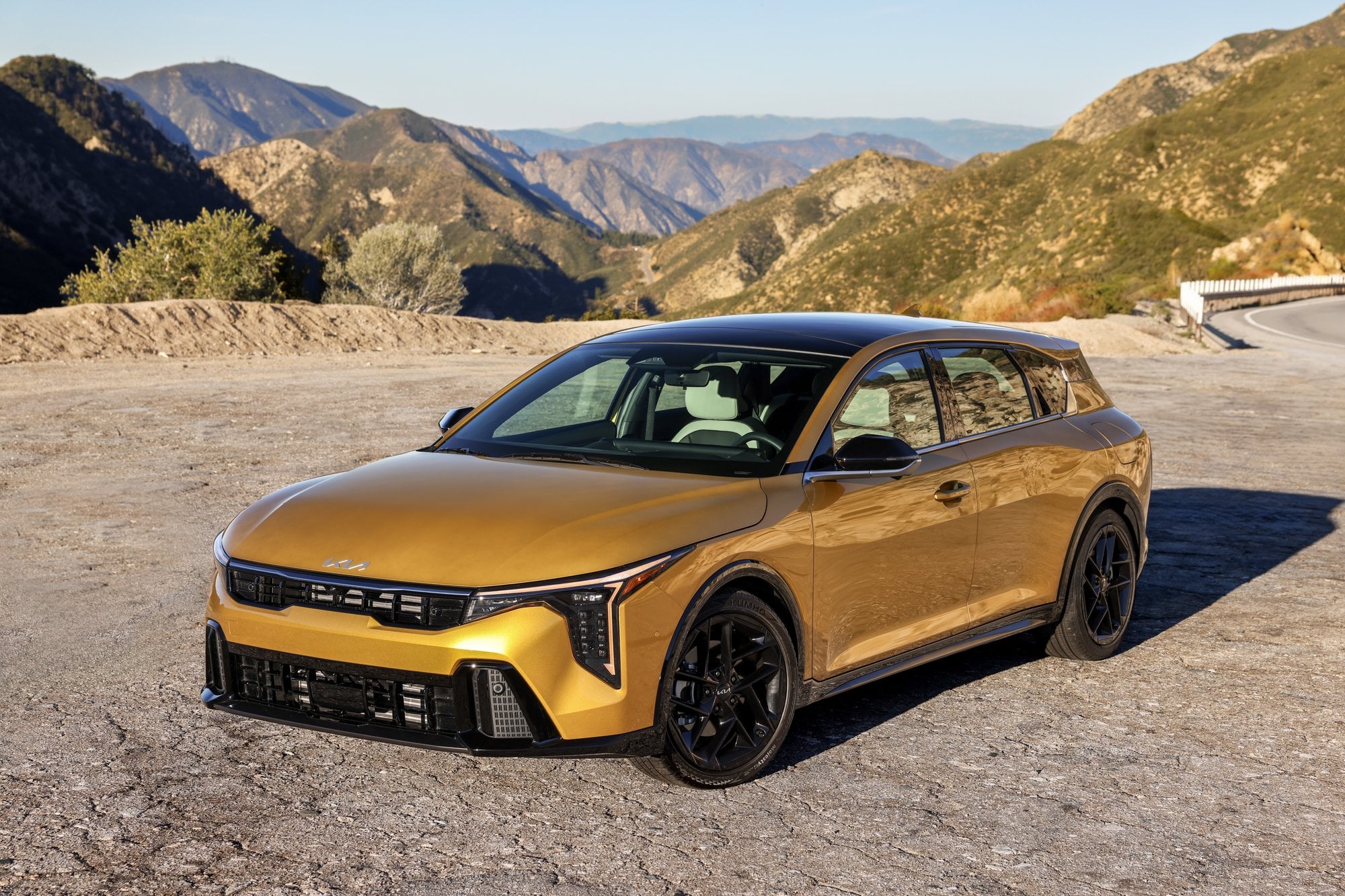 Official Kia photo of 2026 K4 Hatchback front three-quarter at a mountain overlook