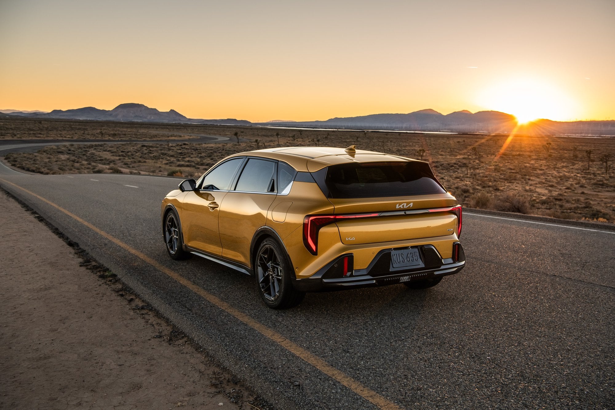 Official Kia photo of 2026 K4 Hatchback rear three-quarter at sunset in the desert