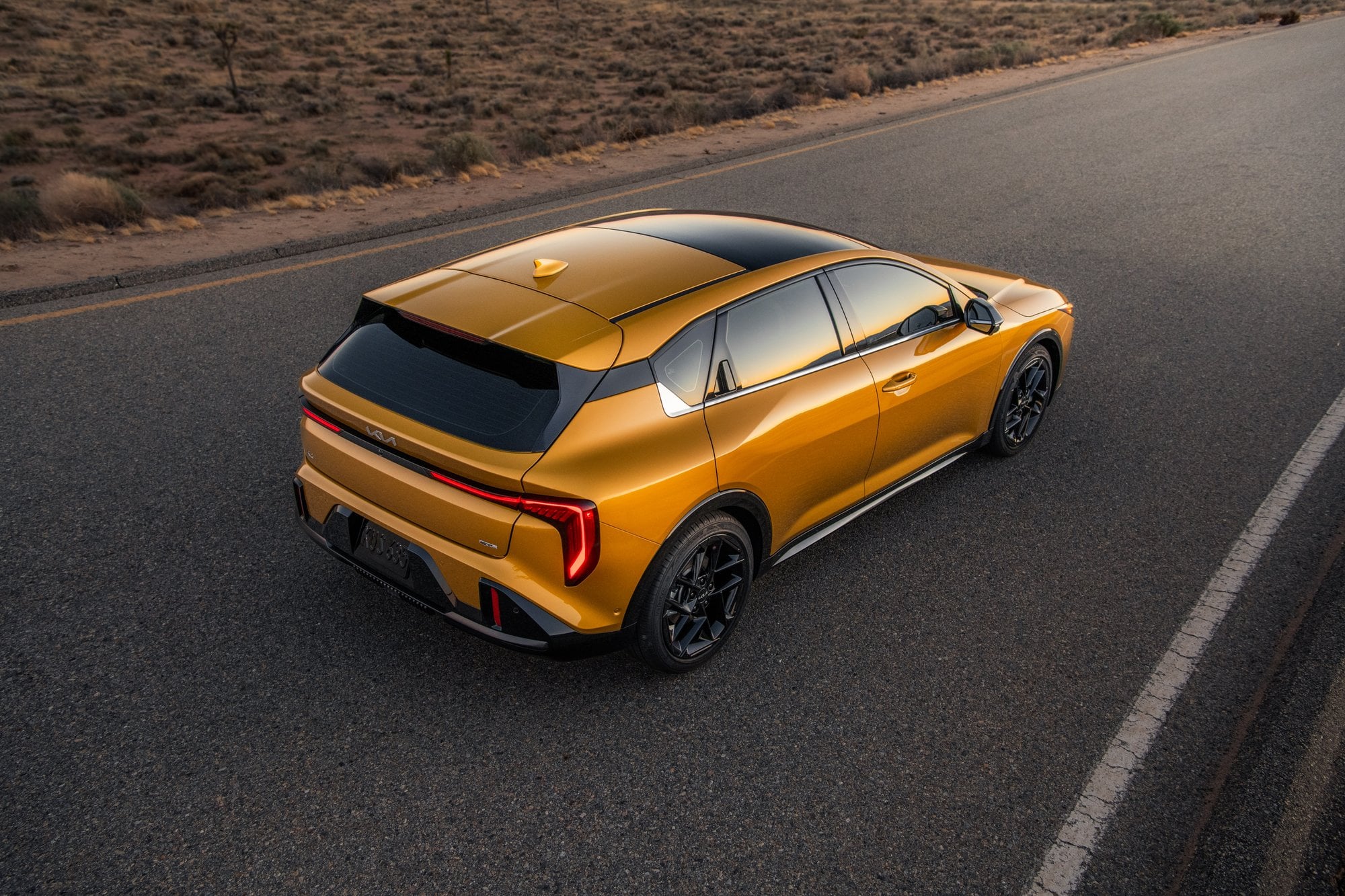 Official Kia photo of 2026 K4 Hatchback rear three-quarter in desert light