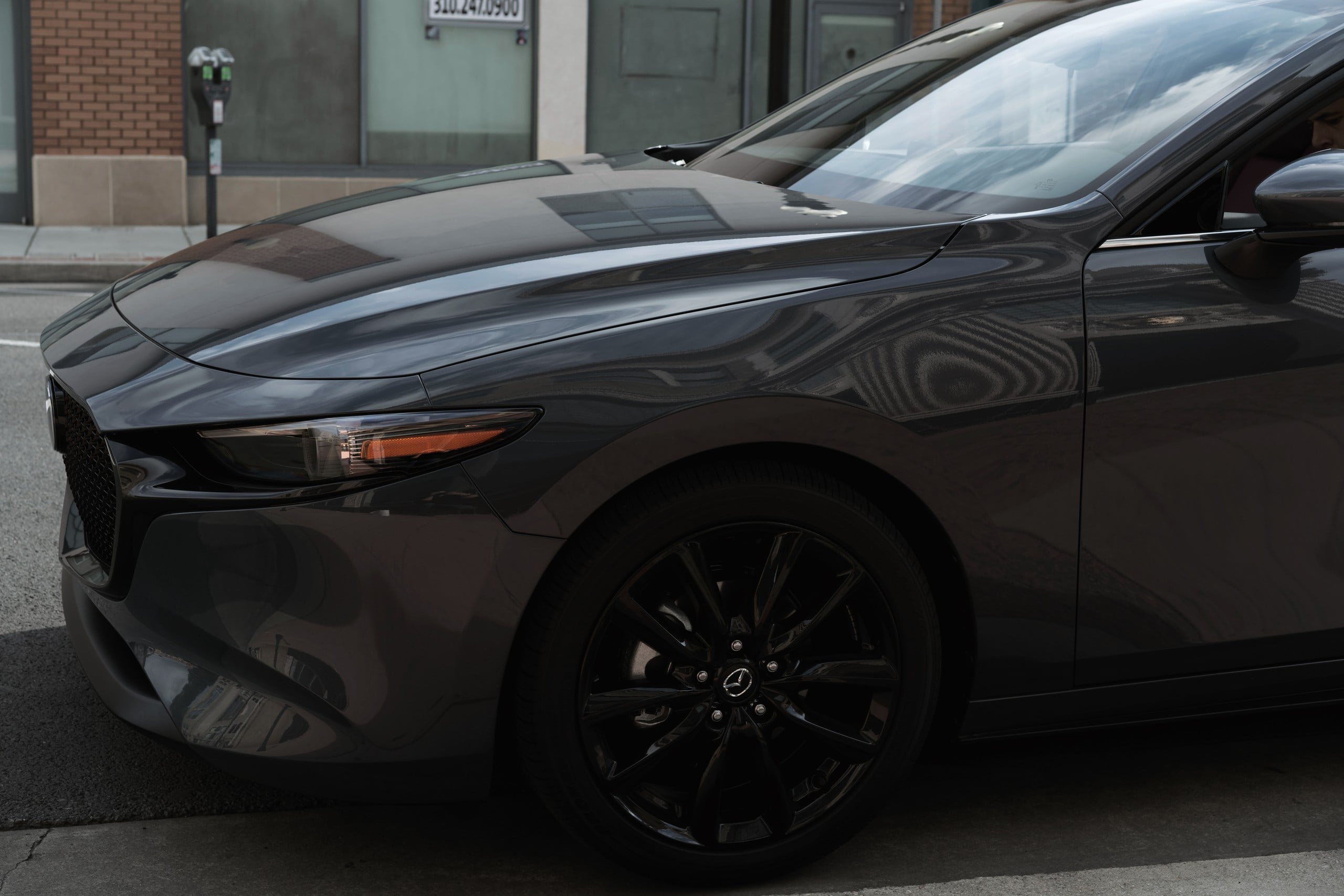 Official Mazda photo of a Mazda3 Hatchback headlight and front wheel