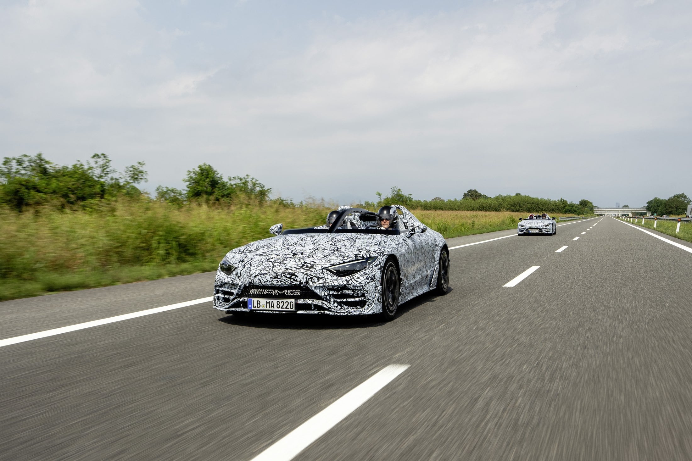 Official Mercedes-AMG photo of camouflaged PureSpeed prototypes on a highway during testing