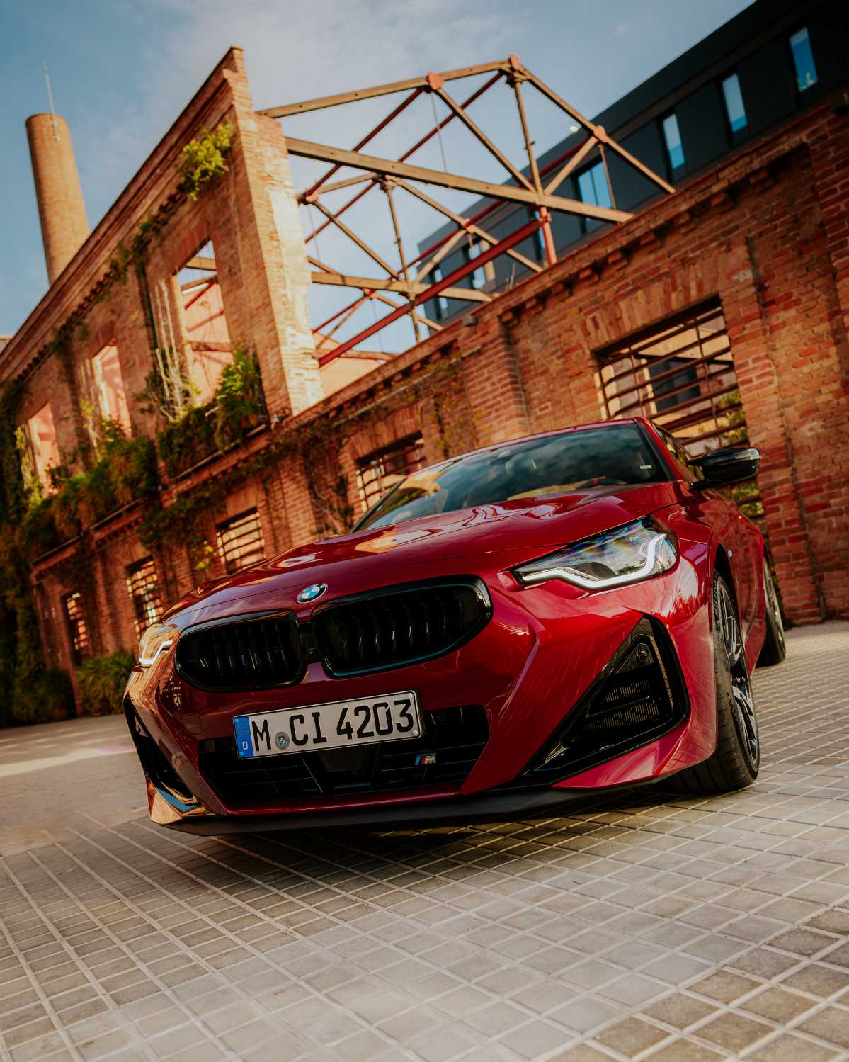 Official BMW press photo of the BMW M240i Coupe low front three-quarter with kidney grille