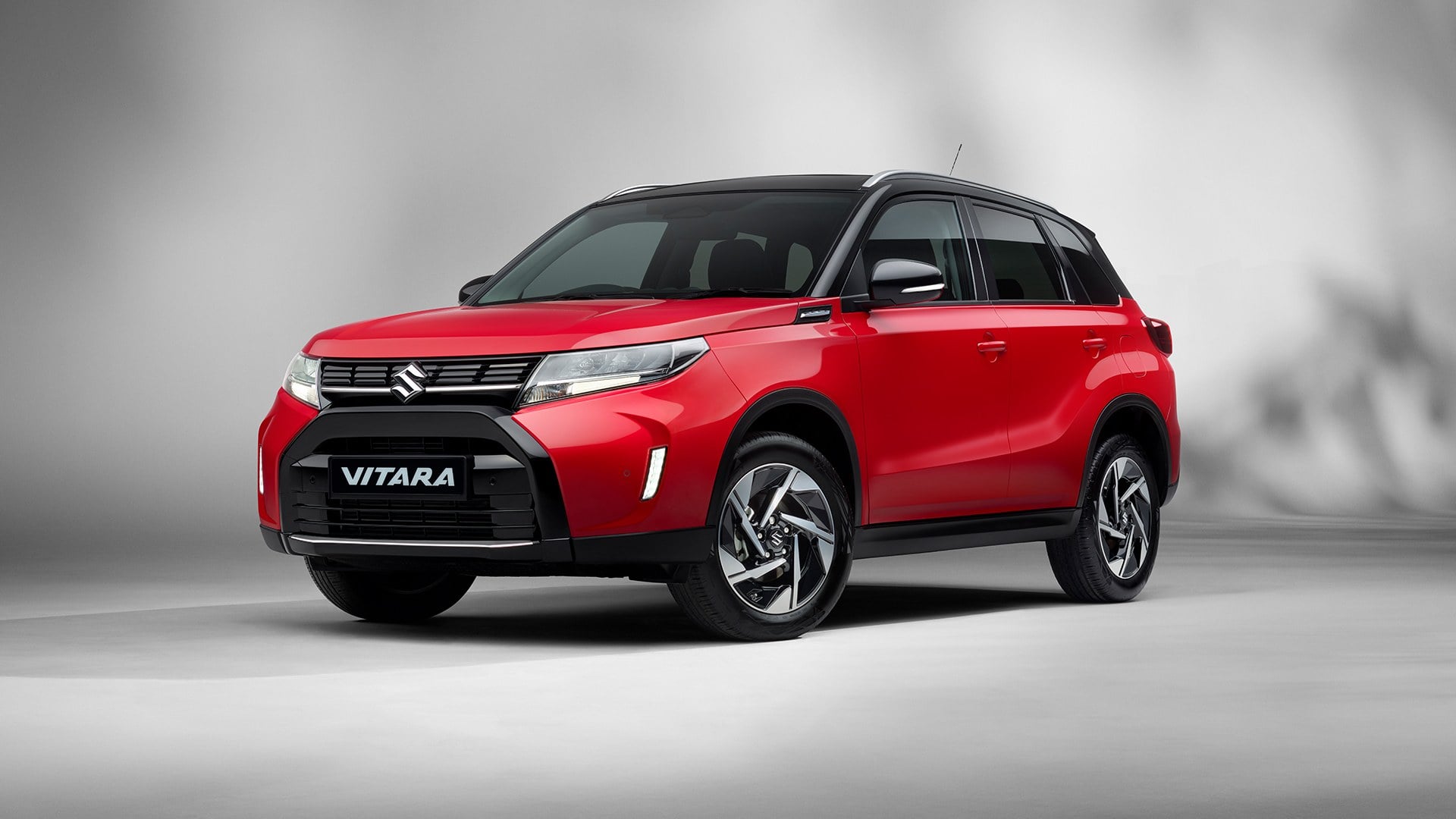 Official Suzuki GB photo of a red Suzuki Vitara with a black roof, front three-quarter view