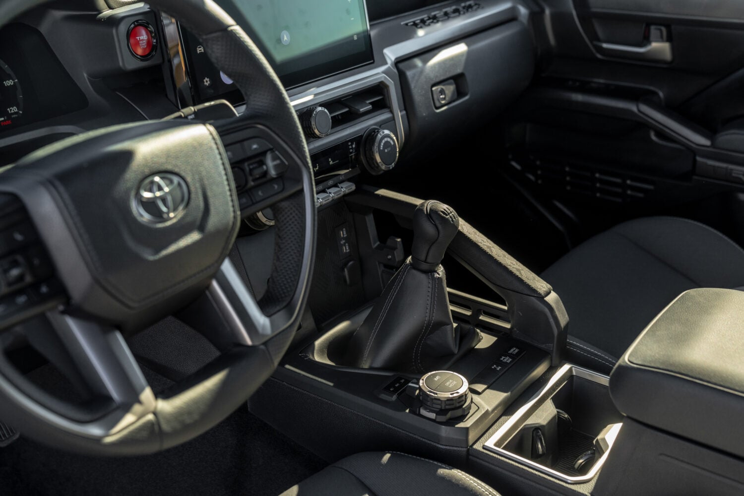 Official Toyota photo of the Tacoma TRD Off-Road cabin with the six-speed manual shifter and 4WD selector