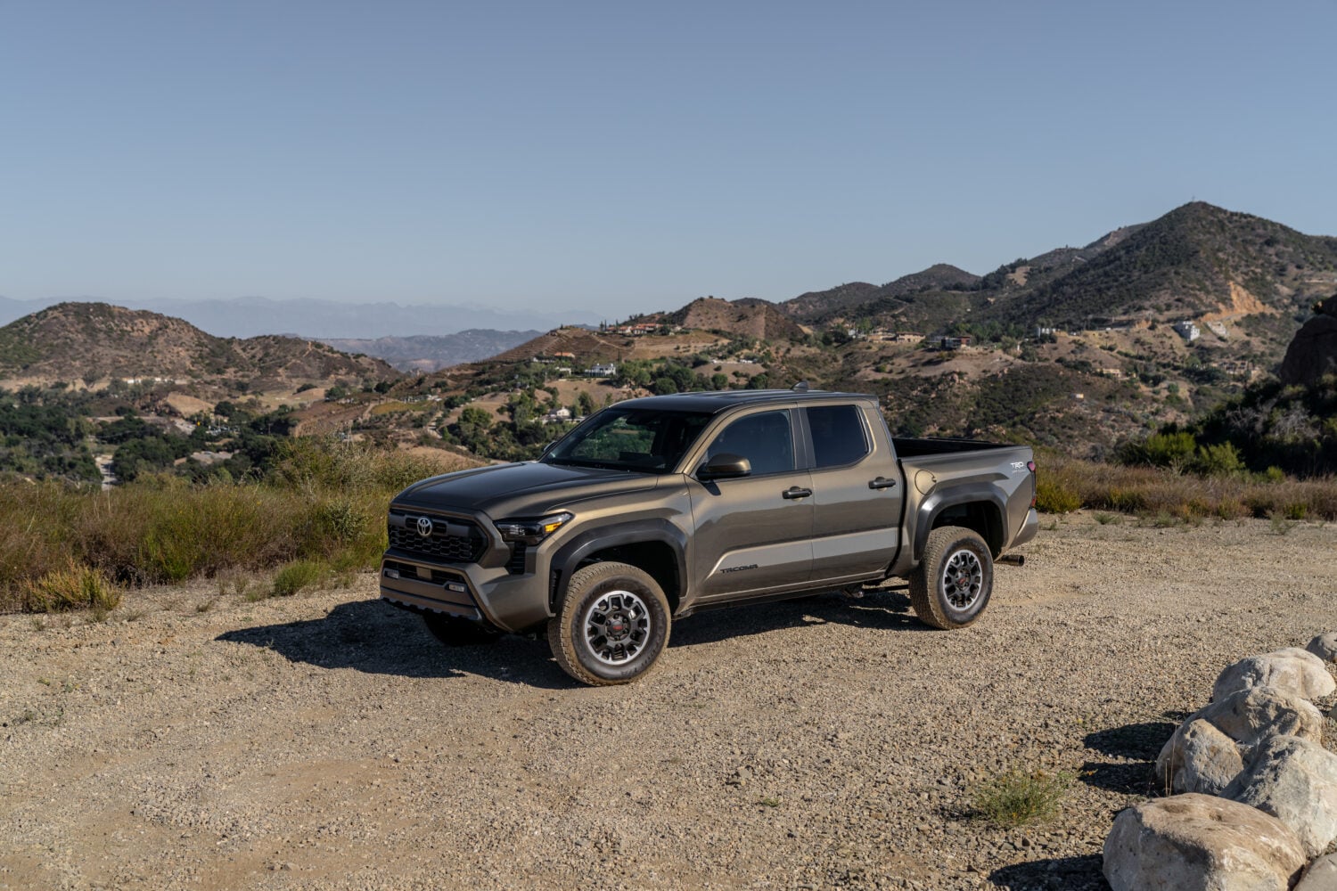 Official Toyota photo of a 2026 Tacoma TRD Off-Road in Bronze Oxide parked on a dirt overlook